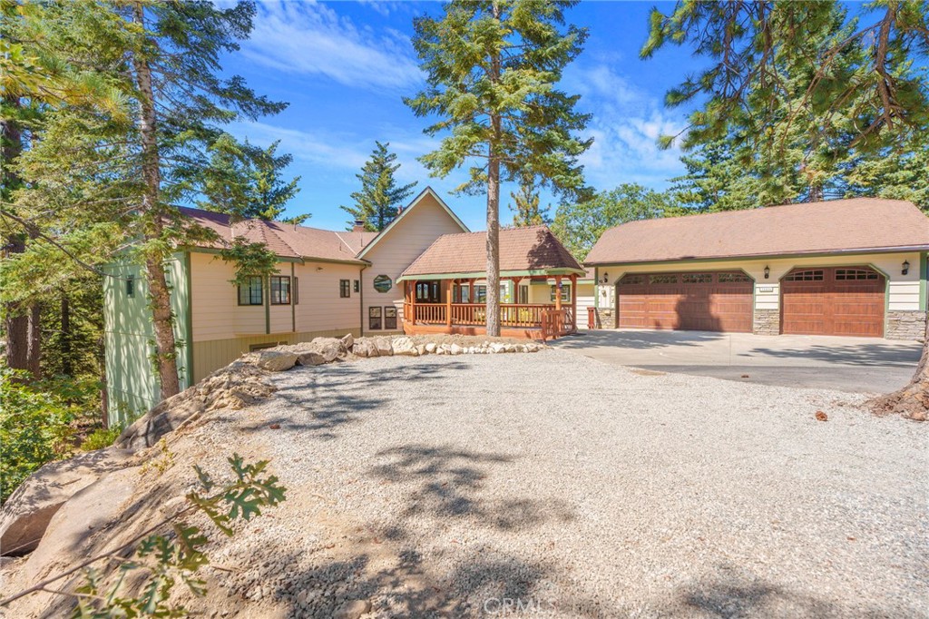 This majestic mountain home features 5686 sq ft of living space and sits on an acre with beautiful forest setting at the end of a cul-de-sac. Located in the desirable area of Rimwood Ranch this 5-bedroom 4- bath estate has so much to offer. The main entry hosts a covered bridge to the front door and large entrance hallway. Large picture windows and knotty pine vaulted ceilings adorn the main floor living room with parque wood floor. The cozy floor to ceiling rock fireplace, dry bar and dining area makes up this main living area. Off the main living area enjoy the gourmet kitchen featuring an eat at island with utility sink & range cook top all surrounded by custom wood cabinets. The formal dining room sits off the kitchen and large laundry room with access to the oversized 3-car garage. Enjoy the redwood decks off this main level with beautiful panoramic forest views. Continuing this main level is an office with built in cabinetry, primary bedroom with full bath, private access to spa and gazebo. Bedroom 2 and full bath make up this first floor. The 2nd floor has a large family/game room with fireplace giving you plenty of entertainment space. 3 more bedrooms and two bathrooms are located off the family-game room area. If that wasn’t enough space a large storage room-wine cellar is located off this great room. Mountain living at its best with just minutes to the local ski resort and hiking trails. It's like owning your own private resort!