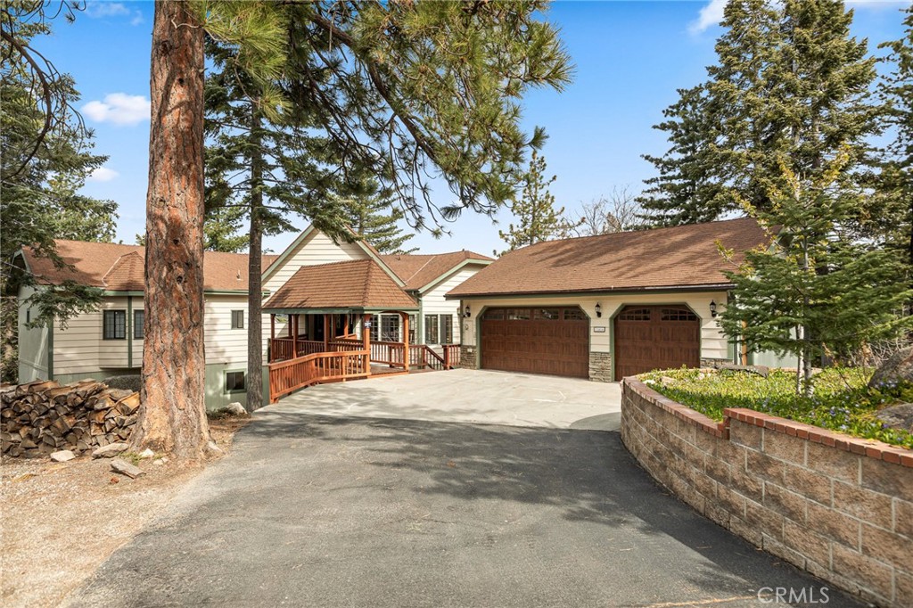 This majestic mountain home features 5686 sq ft of living space and sits on an acre with beautiful forest setting at the end of a cul-de-sac. Located in the desirable area of Rimwood Ranch this 5-bedroom 4- bath estate has so much to offer. The main entry hosts a covered bridge to the front door and large entrance hallway. Large picture windows and knotty pine vaulted ceilings adorn the main floor living room with parque wood floor. The cozy floor to ceiling rock fireplace, dry bar and dining area makes up this main living area. Off the main living area enjoy the gourmet kitchen featuring an eat at island with utility sink & range cook top all surrounded by custom wood cabinets. The formal dining room sits off the kitchen and large laundry room with access to the oversized 3-car garage. Enjoy the redwood decks off this main level with beautiful panoramic forest views. Continuing this main level is an office with built in cabinetry, primary bedroom with full bath, private access to spa and gazebo. Bedroom 2 and full bath make up this first floor. The 2nd floor has a large family/game room with fireplace giving you plenty of entertainment space. 3 more bedrooms and two bathrooms are located off the family-game room area. If that wasn’t enough space a large storage room-wine cellar is located off this great room. Mountain living at its best with just minutes to the local ski resort and hiking trails. It's like owning your own private resort!