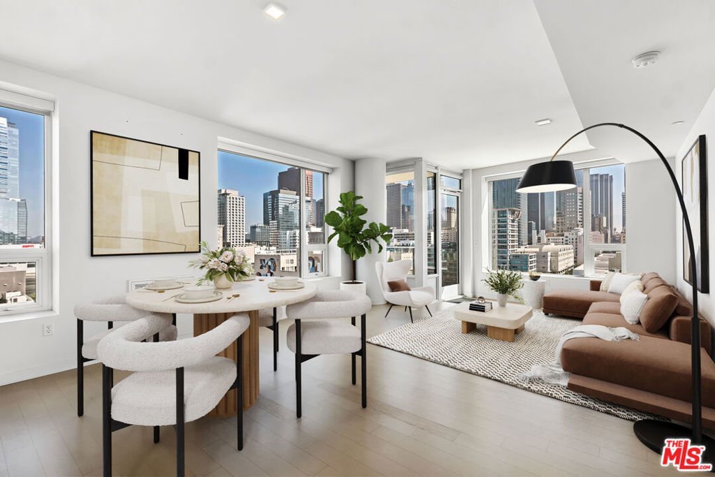 Discover luxury high-rise living in the heart of Downtown Los Angeles at Ten50LA, one of DTLA's most sought-after, full-service luxury residential buildings. This northwest corner 2 bedroom, 2 bathroom hi-rise condo offers breathtaking, iconic skyline views from every room with a private balcony overlooking the entire city. Located in the vibrant South Park district of Downtown, the residence features a light-filled open floor plan with floor-to-ceiling windows, a sleek Carrara marble kitchen island, high-end stainless steel appliances, and custom Domus & Domus cabinetry. The spacious primary suite boasts dramatic city views, a spa-like bathroom with dual vanities, and a custom walk-in closet with built-ins, while the second bedroom is ideally separated for privacy and features its own full bath, built-in storage, and closet upgrades. Residents of Ten50LA enjoy access to premier resort-style amenities, including a rooftop pool and spa with panoramic DTLA views, a fully equipped fitness center, movie screening room, resident lounge, outdoor dining areas, conference room, guest parking, and 24-hour security. This unit includes two secured parking spaces on the B2 level. This luxury residence is ideally located near LA LIVE, Crypto.com Arena, Whole Foods, The Ritz-Carlton, and a variety of acclaimed restaurants like Mastro's, Katsuya and Javier's - placing you steps from the best of dining, entertainment, and shopping in Downtown Los Angeles. With its central location (nearby the world renown USC campus), high-end finishes, and exclusive amenities, this is an exceptional opportunity to own a stylish city residence in the heart of DTLA!