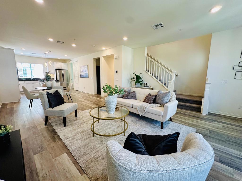 Don't miss this turn-key, bright and light three-story townhome, ideally situated in the town center of the Pacific Highlands Ranch community of Carmel Valley. Leave your car in the garage and enjoy the convenience of walking to amenities, shopping and schools. Overlooking the green belt and lush palm trees, this beautifully designed home offers 3 bedrooms + 1 den, 2.5 bathrooms, and a versatile first-floor den—perfect for a home office, gym, or additional living space. Inside, you’ll find elegant luxury vinyl plank flooring, designer paint, and thoughtfully curated finishes throughout. The spacious open-concept layout includes a gourmet kitchen, a dedicated laundry room, and ample storage space. The primary suite features a generous walk-in closet and a spa-like en-suite bathroom, providing the perfect retreat. An attached two-car garage offers both secure parking and extra storage space. The community itself offers a peaceful, well-maintained setting with green belt, palm trees, playground, BBQ area, and quiet seating spots ideal for relaxing outdoors. What truly sets this home apart is its unbeatable location. You’re just steps from Pacific Highlands Ranch Community Park, the brand-new public library, and The Village at Pacific Highlands Ranch, which offers premier shopping and dining options. Families will appreciate walking to award-winning schools including Pacific Trails Middle School and Canyon Crest Academy. With convenient proximity to I-5 and SR-56, commuting around San Diego is effortless. This is more than a home—it’s a lifestyle upgrade.