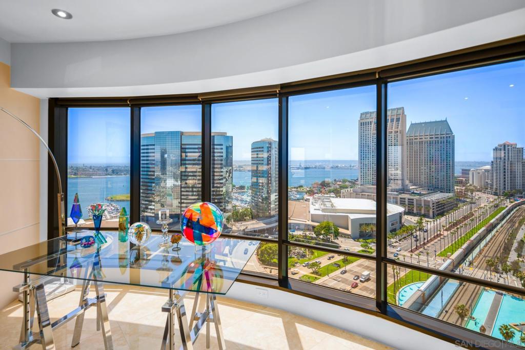 Welcome to one of the most coveted residences in the prestigious Harbor Club — the highly sought-after Bubble Unit, offering truly breathtaking panoramic views of the ocean, bay, harbor, downtown skyline, mountains, and the iconic Coronado Bridge. Enjoy luxury living at its finest in one of Downtown San Diego’s original high-rise gems. This exquisite home is wrapped in floor-to-ceiling windows, bathing the interior in natural light while framing unforgettable vistas from nearly every room. Step outside to a spacious view balcony — perfect for morning coffee, evening sunsets, or simply soaking in the sights and sounds of the city and waterfront below. Thoughtfully designed with elegant finishes throughout, the residence features a gourmet kitchen ideal for entertaining, and formal living and dining areas that exude sophistication and comfort. The expansive primary suite is a serene retreat with sweeping views and a spa-inspired ensuite bath, complete with a soaking tub and separate walk-in shower. A spacious guest bedroom with stunning views and a murphy bed plus a stylish second bath with a walk-in shower completes this exceptional floorplan. Harbor Club is a secure, private community offering full-service luxury amenities, including 24-hour concierge, on-site property management, and security. Recent upgrades to the resort-style common areas include a sparkling pool, spa, sauna, state-of-the-art fitness center, clubhouse, BBQ areas, firepits, and beautifully landscaped sitting areas. Perfectly situated in the vibrant Marina District, you’re just steps from Seaport Village, the Rady Shell, Ruocco Park, fine dining, boutique shopping, and convenient access to the trolley and train. This home offers the ultimate combination of peaceful waterfront living and the excitement of downtown just outside your door.