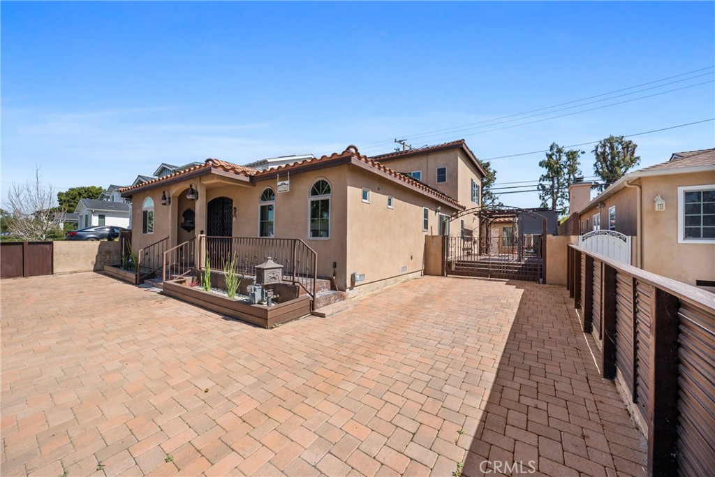 Experience LUXURY LIVING at its finest! REMODELED and Designed with meticulous detail from the foundation to the roof in 2017. This exquisite home boasts 5 Bedrooms and 4 SPA-INSPIRED Bathrooms. Enjoy this home’s elegance as you walk through the double-door entry to the open-concept Living Space. The GOURMET kitchen is equipped with top-of-the-line appliances, which include a VIKING 6-burner STOVE, VIKING OVEN, SUB-ZERO double door refrigerator, with beverage dispenser, microwave drawer, and dishwasher. In addition, there’s a copper sink, SOLID WOOD cabinetry with plenty of STORAGE, and an OVERSIZED ISLAND. The 1st level also includes the dining area, it is multi-functional and includes a hidden washer/dryer, a buffet countertop with a sink, and additional storage. Conveniently located is the first of TWO PATIOS for outdoor entertainment. The second patio is a covered patio with a play area and additional space to relax. In addition, you'll find three rooms—one with an attached full bath—an office/den, and a spacious bedroom with an adjacent full bathroom. The upstairs primary suite is a PRIVATE RETREAT with a generous WALK-IN CLOSET, built in OFFICE SPACE, large windows, and a beautifully remodeled en-suite bathroom with elegant double COPPER SINKS and a JETTED SOAKING TUB. This lovely home also offers HARDWOOD FLOORING, DESIGNER TILES, Fresh Sherwin-Williams paint, a durable tiled roof, Fibercon decking, a whole-home WATER FILTRATION system, a TANKLESS water heater, ENERGY EFFICIENT SOLAR PANELS, a surround SOUND SYSTEM, and a smart home-controlled lighting system. Designed with practicality in mind, the landscaping is low-maintenance and cost-effective. The beautifully paved driveway offers secure parking, while the Fully Fenced Yard offers security. Just steps from the award-winning El Marino Language School, this prime location is walkable to upscale shopping, dining, parks, and top-rated schools. *Property is unfurnished, photos include virtual staging.