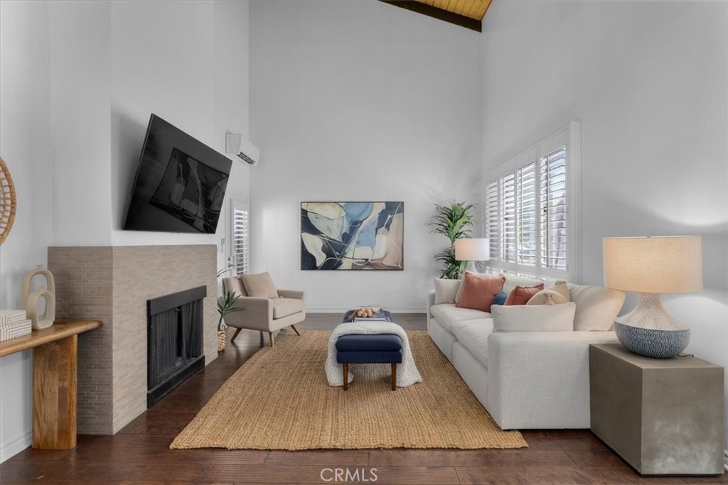 A rare offering! This top-floor 985 sq ft unit boasts the highest ceilings in the coveted Windsor Fountains community in Culver City. Step inside to an inviting open layout with a dining area and living room highlighted by soaring vaulted ceilings and a decorative fireplace. The kitchen features Caesarstone countertops, freshly painted cabinets, a custom backsplash, a newly reglazed sink, and recessed lighting. Down the hallway, you’ll find the updated bathroom with a skylight and new light fixture. The spacious primary bedroom includes a custom California Closet walk-in, built-in wall safe, and access to the private balcony. Upstairs, the loft offers a flexible space - ideal for the second bedroom, an office, or hangout area. Enjoy year-round comfort with three mini-split A/C and heating units located in the loft, living room, and primary bedroom. Additional highlights include wood flooring, white window shutters, and two tandem covered parking spaces. In-unit washer and dryer installation is permitted with HOA approval, and HOA dues cover all utilities except electricity and cable/internet. Windsor Fountains offers a wide range of amenities, including a pool, spa, tennis courts, clubhouse, recreation room, laundry facilities, landscaped grounds, and onsite management. Conveniently located near the Ballona Creek Bike Path, Downtown Culver City, One Culver, boutique shops, and restaurants - and within the highly rated Culver City School District. This is truly a must-see!
