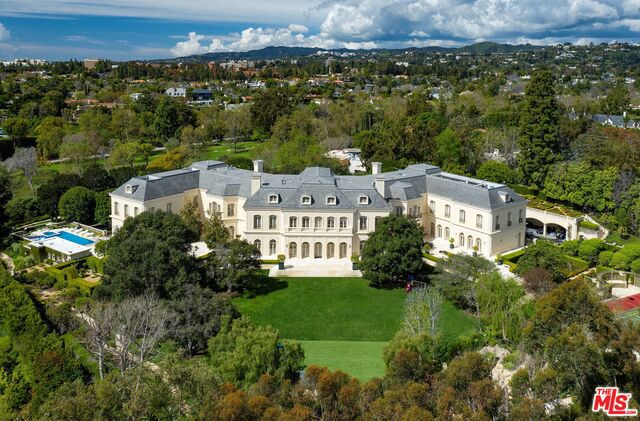 The Manor is one of the largest and grandest private residences in LA. Originally built by entertainment royalty Aaron & Candy Spelling and exquisitely reimagined, the property is sited on nearly 5 flat acres in the coveted Platinum Triangle. The approx. 56,000 SF mansion represents the perfect marriage of visionary design and timeless grandeur. Bordering the renowned LA Country Club and shielded behind gates and hedges, a winding drive leads to a circular motor court with space for 100 cars. A magnificent entry with 30-foot ceilings and a grand double staircase leads to breathtaking living spaces, including a stunning solarium, formal & informal dining, library, family room, state-of-the-art theatre, chef's kitchen, billiards room, bowling alley, gym, wine cellar and beauty salon. Extraordinary grounds include a resort-caliber pool and spa, championship tennis court, vast lawns and beautiful formal gardens. Moments from downtown Beverly Hills, Rodeo Drive and The Beverly Hills Hotel.
