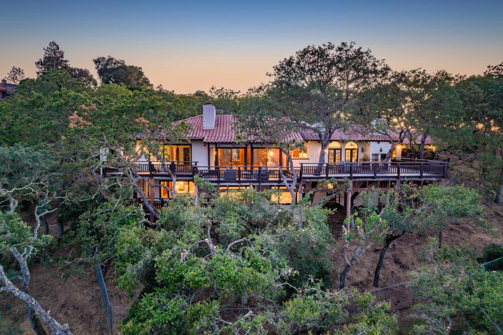 Located in central Westridge, the most sought-after area in all of Portola Valley, this property offers an exceptional setting with myriad possibilities & the opportunity to transform it into a dream vision. Home exudes an organic contemporary style with a Spanish flair, characterized by signature details like decorative tile stair rises & wrought-iron lighting. Home retains its original charm with all-wood cathedral ceilings, tiled floors in most public rooms, & in the primary suite, & naturally finished wood cabinetry topped with tile. Expansive windows & sliding glass doors open to spacious deck built around mature trees, offering views of the East Bay Hills & the surrounding natural beauty of Portola Valley. Main living area is open & especially spacious featuring a sunken conversation pit - a distinctive-of-the-era design element perfect for entertaining. There are 3 bedrooms & 3.5 baths plus a bonus room which possibly be a 4th bedroom. Set on approximately 3.2 acres, the grounds offer exceptional privacy & ample space for future pursuits. The nearby Westridge Trail provides access to miles of hiking, biking, & equestrian trails, renowned throughout Portola Valley. This property presents an unparalleled opportunity to create a personalized dream home in an idyllic setting.