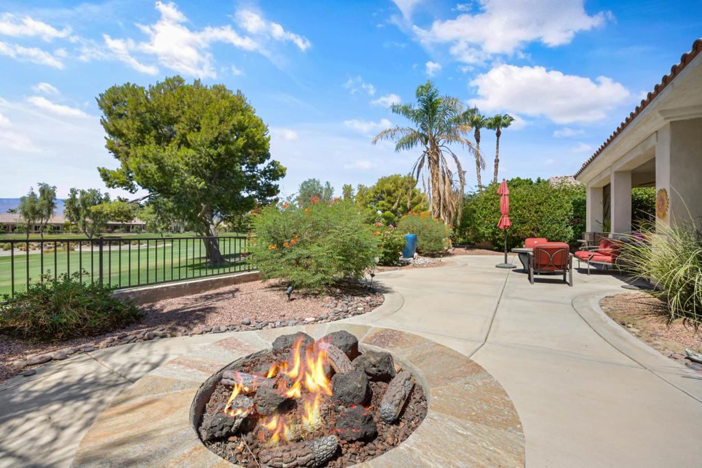 Nestled within the prestigious 55+ active adult community of Sun City Shadow Hills, this impeccably maintained Madera floor plan offers 1,854 square feet (EST.) of refined living space, thoughtfully designed for both relaxed comfort and effortless entertaining. This elegant 2-bedroom plus den, 2-bath home boasts an open-concept layout, featuring custom window coverings, tile flooring throughout the main living areas and warm wood-like flooring in the bedrooms for a sophisticated touch. The chef's kitchen is a culinary dream, showcasing granite countertops, stainless steel appliances, double ovens, and a generous center island that flows seamlessly into the light-filled living and dining areas--perfect for hosting family and friends. The expansive primary suite is a tranquil retreat, complete with dual vanities, a luxurious soaking tub, a walk-in shower, and a spacious walk-in closet. A separate guest bedroom and a flexible den or office provide both privacy and versatility. Step outside to a serene, covered patio framed by lush landscaping and elevated southern golf course views. Unwind in your private above-ground spa as you take in the peaceful surroundings. Residents of Sun City Shadow Hills enjoy access to world-class amenities, including two beautifully appointed clubhouses, resort-style pools, tennis and pickleball courts, state-of-the-art fitness centers, championship golf, and an exciting calendar of social events. This is desert resort living at its finest--an absolute must-see!