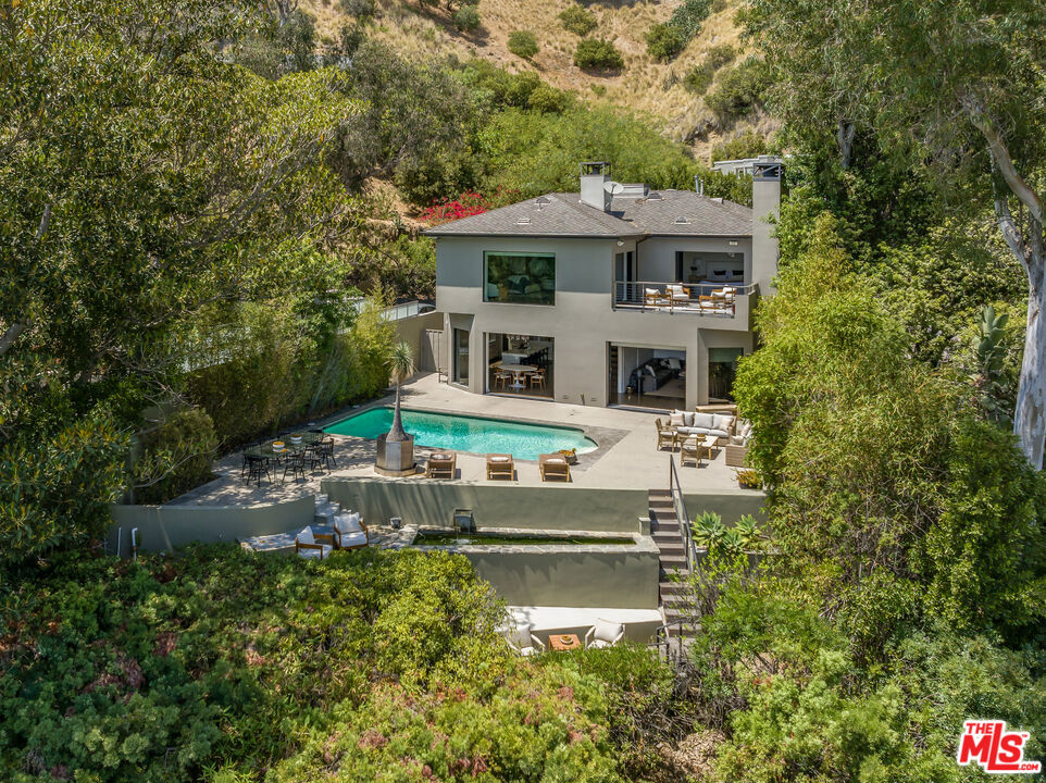 Designed by the acclaimed Marmol Radziner, this stunning contemporary residence offers breathtaking panoramic views from downtown to the ocean, exceptional craftsmanship, and an unbeatable location in prime sunset strip, second from all the action! The open-concept design seamlessly connects the entertainer's kitchen, dining area, and flexible living space easily convertible into a private theater to an expansive outdoor retreat. Enjoy unobstructed city light views from the sun-drenched pool, outdoor shower, built-in BBQ, and elevated terrace, creating the perfect setting for relaxation and entertaining. The residence features beautifully updated bathrooms, floors, modernized appliances, and upgraded air conditioning and heating systems for ultimate comfort and style. Upstairs, dual primary suites feature floor-to-ceiling pocket doors, fireplaces, oversized walk-in closet, and dedicated office space, all opening to a fireplace-lit terrace with mesmerizing skyline views. This turnkey modern masterpiece is an extraordinary opportunity to own in one of Los Angeles' most sought-after neighborhoods.