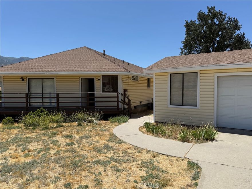 This family home at 18901 Pinehurst Pl, in Tehachapi at the tip of Stallion Springs proper, features 3 bedrooms and 2 bathrooms, a wrap around porch, and sits on a 0.52 acre lot. Built in 1980, the property includes two built storage sheds and one detached 2-car garage. Although the house is listed as a one story, it does have access to an upstairs loft for additional office space. The property is being sold As-Is, priced accordingly, and Seller Motivated. The area is known for its scenic beauty and proximity to local amenities.