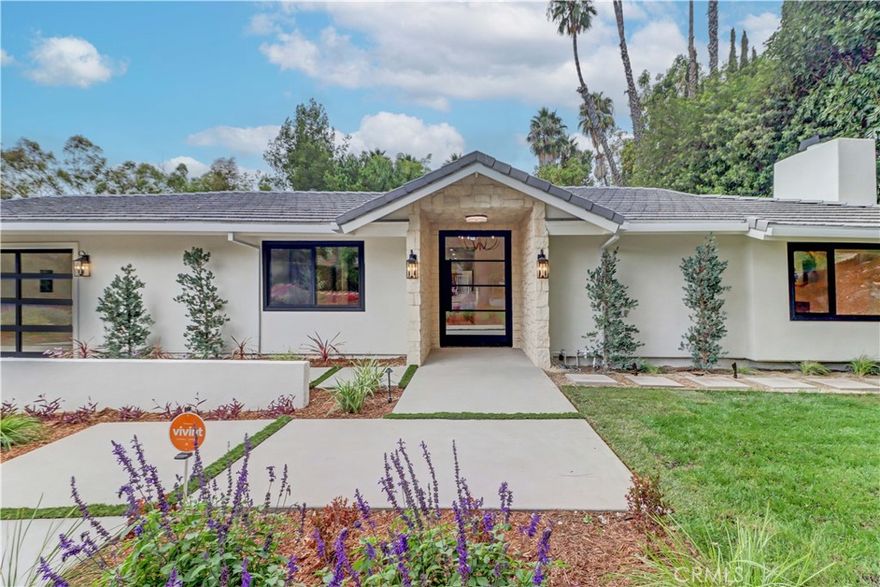 Searching for a single-story modern masterpiece tucked away amid the gentle slopes of North Tustin? This fully renovated 5-bedroom, 3-bath residence in the prestigious Cowan Heights neighborhood blends architectural elegance with everyday functionality on a private 0.37-acre lot, surrounded by mature trees and hillside serenity!



From the moment you arrive, many sleek black-framed dual-pane windows and a custom metal pivot door set the tone for the design-forward touches that continue throughout the home. A striking stone archway and chandelier welcome you into an open floor plan filled with natural light from strategically placed skylights. Smooth drywall, soothing neutral hues, luxury vinyl flooring, and contemporary finishes create a clean, organic aesthetic that's both stylish and comfortable.



The generous living room, centered around a sculptural bespoke plaster fireplace, flows effortlessly into a nearby dining alcove and kitchen ready for conversation and culinary endeavors. Cook with confidence using the French-inspired range beneath a handcrafted hood, surrounded by quartzite countertops, abundant cabinetry, stainless steel appliances, and a multi-seater island suitable for casual gatherings. A new mud room with a substantial pantry adds to the abode's many flexible spaces.



Retreat to the primary bedroom with its patio access and spa-like ensuite featuring an oversized frameless shower with dual showerheads. A junior suite offers its own exterior entrance, pass-through bath, and a separate sitting area—ideal for guests or multi-generational living. Every bath and closet door in the residence is customized, and each shower features luxurious tile work, creating a sense of refined craftsmanship everywhere you turn.



Stunning French and sliding glass doors invite you into a secluded courtyard or custom-landscaped backyard where synthetic grass, new concrete embellishments, and views of the adjacent ravine offer an idyllic outdoor escape. The fenced side yard is perfect for weekend BBQs or evenings with cocktails under the stars.



You’re conveniently located just a short drive from shopping destinations, a multitude of entertainment options, and the nature trails of Santiago Canyon and Irvine Lake. This home also offers proximity to award-winning schools in one of Orange County’s most sought-after communities. Come see how design, comfort, and character come together at this striking haven and imagine yourself a part of it all!