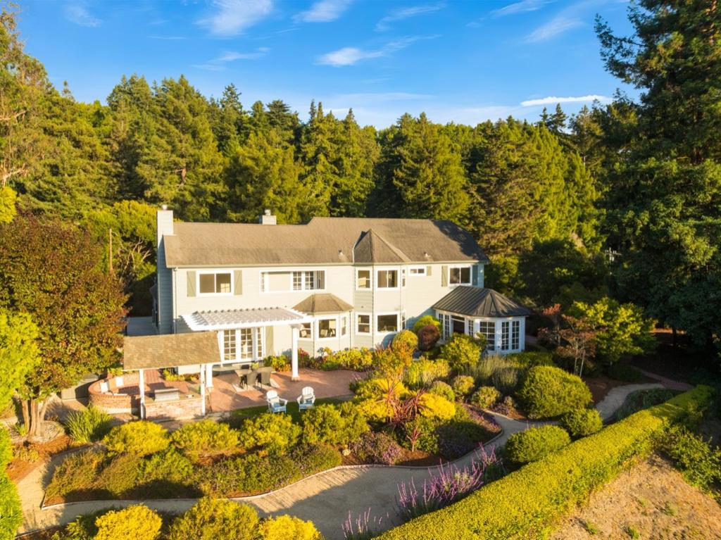 Steps off Cherryvale Avenue, one of Santa Cruz Countys most coveted roads, Saturday feels perfect when youre driving home from a day in downtown Soquel & Capitola Beach with sandy kids in the backseat, knowing your family gathering awaits. You pull through your private gate while kids are already planning their evening adventures on the property. Main Street Elementary sits just down the street for easy school drop off. The valley spreads out below with that golden light hitting the farmland as kids race out of the car & head to pick fresh vegetables from the greenhouse for dinner while adults fire up the built-in grill. Your sun room fills with arriving family members, drinks in hand, settling into those valley views while kids play on the property. The outdoor kitchen becomes family headquarters where dinner happens organically. As sunset paints the valley, generations gather at the firepit where the brick seats accommodate everyone. Stories flow while smores get passed around under the stars. Three fireplaces inside offer backup for little ones who get cold, but most nights the outdoor spaces win. By the time the last family car winds down your driveway, the kids are already planning the next sleepover. Some places just make families want to gather.