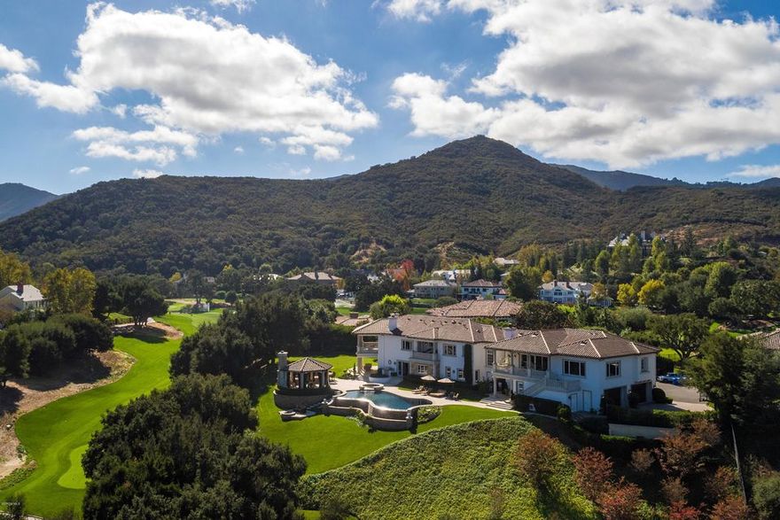 Set behind Sherwood Country Club gates, this pedigree estate is the ideal retreat in a prestigious setting. The 2-story foyer & spacious living areas create delightful interiors. The formal dining room embodies elegance & the remodeled kitchen features Callacatta marble counters & panoramic views, connected to the sun-filled living room. Designed to impress, the master suite includes a private balcony, sitting area & fireplace. The media suite includes a theater, game room, fitness center & overlooks the golf course fairway. Enjoy the best al fresco dining with an outdoor kitchen, fireplace & infinity pool. This property is an ideal celebrity estate spanning nearly 2 acres of private hillside with a verdant lawn with an oak grove creating a natural setting with privacy & marvelous views.