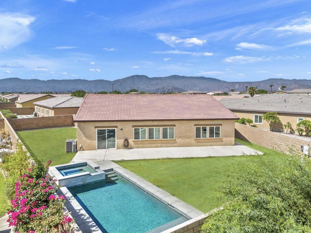 Welcome to this stunning home in the highly desirable gated community of Hacienda, proudly offered by the original owners. Nestled at the end of a quiet cul-de-sac, this property sits on an oversized lot with a sizeable side yard, offering ultimate privacy--no neighbors directly behind--and beautiful mountain views. Enjoy the brand-new custom pool and spa (2023) featuring pebble tec finish, party lights, and smart remote control via app--perfect for relaxing or entertaining. Inside, the home boasts 4 bedrooms plus a den, ideal for an office, media room, or extra guest space. The kitchen is a chef's dream with white cabinetry, stylish backsplash, stainless steel appliances, a large island, and a double door pantry. Additional upgrades include plantation shutters, updated light fixtures, and more. Located within the IID electric district for lower energy costs and a low $125/month HOA, this home blends functional and comfortable living. A must-see!