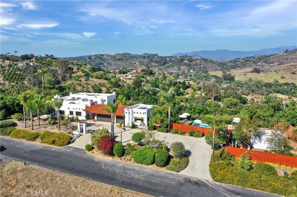 Absolutely Stunning Spanish style retreat Estate on 1.16 acre lot with brand new swimming pool, hot tub and redesigned backyard with avocado & citrus grove. Huge views overlooking the serene Gird Valley area known for its fabulous vineyards and wineries.
This 3,358 sq. ft gated home Estate features all the details of a Spanish style home including impressive Saltillo tile, viga and latillas ceilings, and custom tile work throughout.
The Spanish theme of this home also flows into the fully rebuilt and remodeled attached 1 bedroom studio ADU complete with a kitchenette, bathroom and private entrance.
The split level home has an upstairs master retreat with an attached bonus room ideal for an office or nursery plus a walk through closet to the spacious master bath, and a private master bedroom balcony overlooking the magnificent views with a beautiful custom hacienda blue steel railing.
The new Speakeasy includes a Pool Table, Flat Screen TV's, Bar and much more.
Downstairs you'll find 2 additional remodeled bedrooms two of which have private entrances, a full bathroom completely remodeled and reconfigured, and an additional Den / Bedroom with a fireplace and private entrance.
This home is perfect for multi-generational living or you can leverage the current use as a fully booked High End Short Term Rental Property. The custom kitchen is complete with cedar cabinets, leathered quartz countertops, butcher block island, and a beautiful hammered copper
This home has been completely remodeled and includes upgraded Milgard windows, with a lifetime warranty, maintained saltillo tile sealing, decks recently stained and/or painted, nearly new tile roof, custom tile flooring in the master bath, and fencing around the entire property.
To complete this gorgeous home is OWNED SOLAR and a spacious three car garage. There is a separate entrance from the street to the rear yard that is level and partially paved with its own gated entrance making it an ideal spot for building a guest house, tiny home or RV for future added income.
No HOA's or Mello Roos located on a private road that was recently paved. The property is just a couple minutes off of Gird making for a quick an easy commute to the 76 and I-15 freeway or head west on the 76 for a quick drive to the Oceanside beaches and pier.
This is a must see for someone looking for a very special property.