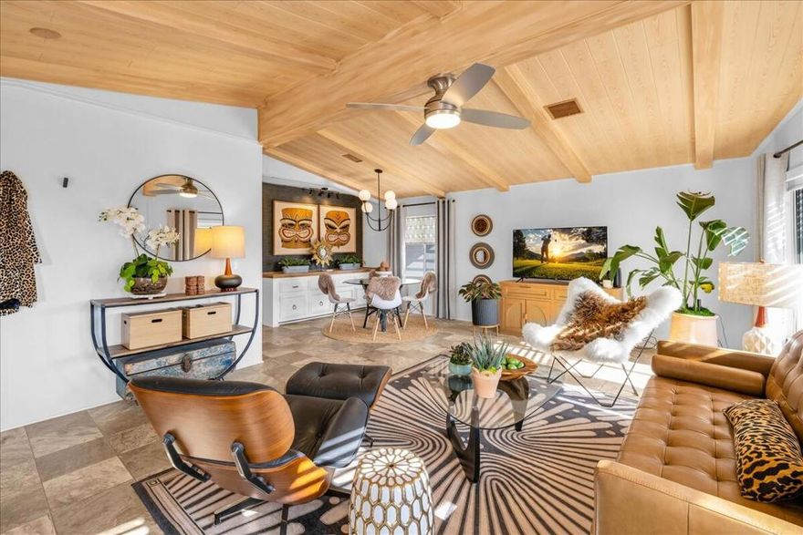 This beautifully updated 2-bed, 2-bath home in Palm Desert Greens Country Club offers modern style, sweeping mountain views, and resort-style living. Set on a new permanent foundation with a brand-new roof, this 1,440 sq. ft. home sits on fee simple land (you own it). The bright living area features vaulted ceilings and large windows, while the kitchen includes stainless steel appliances and a retro vibe. The remodeled primary suite offers a spacious walk-in shower and fresh, contemporary finishes throughout. Enjoy unobstructed mountain views and no rear neighbors, with open green space directly behind the home.Located in a 55+ guard-gated community with low HOA dues covering golf, pools, fitness center, and more. Move-in ready, beautifully updated, and perfectly situated -- your Palm Desert paradise! Property is staged. Photos taken prior to seller's move out.