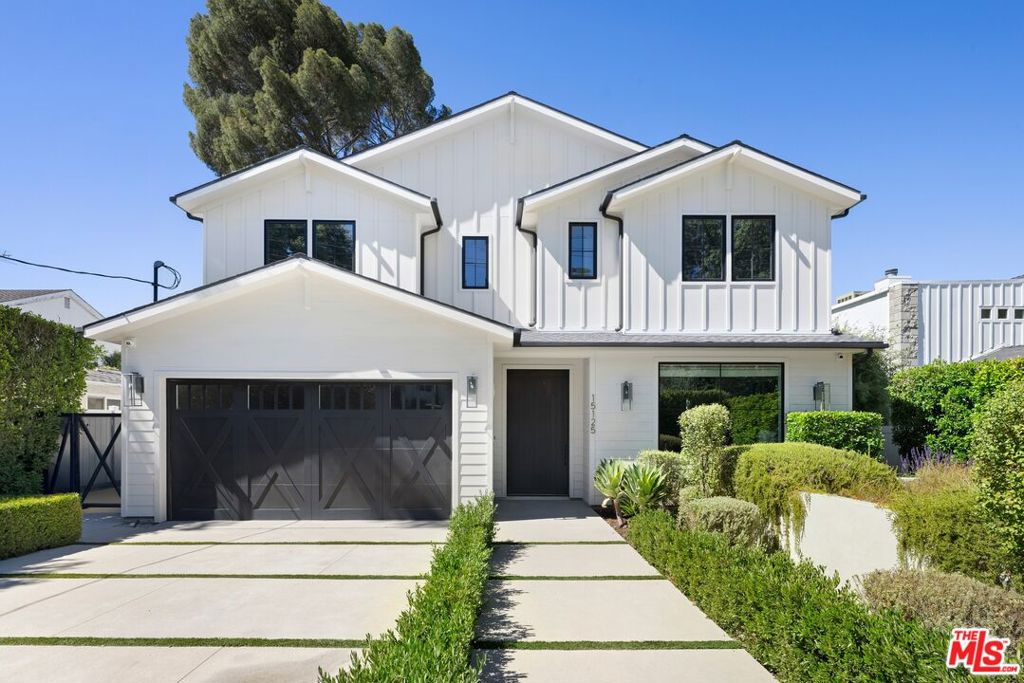 Set back from a desirable tree-lined street south of Ventura Boulevard amidst well-manicured landscaping, this impeccable Modern Farmhouse offers fantastic curb appeal and a variety of outdoor spaces in a prized locale. Warm woods flow overhead, from the welcoming living room with its picture windows to the elegant dining room with a floor-to-ceiling wine display, completing the home's overall organic ambiance. The family room features a gorgeous fireplace with wood storage alcove, flanked by open shelving and built-ins, plus pocket doors that open to the rear grounds. The adjacent kitchen is tastefully appointed with an oversized quartz center island with breakfast bar, deep charcoal cabinetry, beautiful backsplash, butler's pantry with beverage refrigerator, and nearby eat-in space. For guests, the powder room seals the home's Modern Farmhouse vibe. Upstairs, the primary suite is vast, with paneled vaulted ceilings, fireplace, built-ins, spa-inspired bath with massive rainwater shower and separate tub, and dual owner's walk-in closets. Secondary bedrooms and bathrooms are light-filled and fitted with the finest contemporary materials. Laundry is centrally positioned, and there is also an office with French doors to the outside. In the backyard, enjoy a built-in barbecue for entertaining guests and dining al-fresco. There is also a fire table, perfect for evening conversation, next to the beautiful pool and spa with baja entry. The pool/guest house is complete with a full bath and sliding glass doors opening poolside. Welcome to one of the very best neighborhoods in coveted Sherman Oaks, close to the many shops and eateries along Ventura Boulevard, the 405 and 101 Freeways, the Galleria, parks, top-rated Sherman Oaks Elementary Charter, and more!