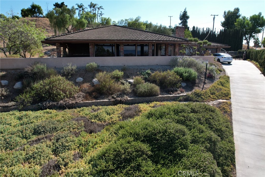 Welcome to 15471 Washington Street — a beautifully maintained 4 bed, 2 bath single-story ranch-style home on a private 0.91-acre lot. This 2,006 sq ft residence offers spacious living, updated finishes, and energy-efficient solar. Inside, enjoy an open living and dining space with floor-to-ceiling windows, wood-style flooring, and striking natural light. The kitchen features rich wood cabinetry, mosaic tile backsplash, and stainless appliances. A fully remodeled primary bath boasts dual vanities and a walk-in shower. The terraced lot includes multiple outdoor living areas, mature landscaping, a water fountain, and a covered patio with an outdoor sink. Additional highlights: beamed ceilings, indoor laundry with garden access, RV parking, and a detached shed. Room to roam, garden, or add future amenities. A rare blend of charm, privacy, and usable land—don’t miss this opportunity!