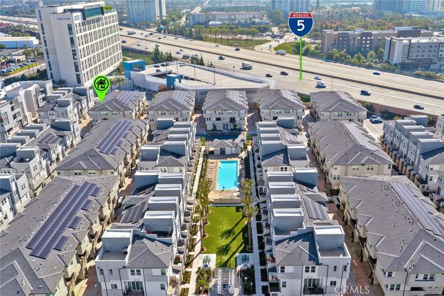 Step into modern California living with this sleek three-story townhouse, perfectly situated in Anaheim’s dynamic new-home community. Built in 2022, this residence offers 2 bedrooms, 2.5 baths, and approximately 1,242 sq. ft. of thoughtfully designed living space.

From the moment you arrive, you’ll appreciate the two-car attached garage and gated community access for added comfort and security. The main living level features an open-concept design with upgraded wood-style flooring, abundant natural light, and seamless flow between the living room, dining area, and kitchen. The gourmet kitchen is a true highlight — showcasing quartz countertops, a full tile backsplash, a six-burner gas cooktop, and premium stainless-steel appliances. Step outside to your private second-floor balcony, ideal for morning coffee, evening relaxation, or entertaining with a view of the landscaped courtyard and community spaces. Upstairs, you’ll find two spacious bedrooms, each with its own ensuite bathroom for maximum comfort and privacy. The primary suite impresses with full-height tile surrounds, a walk-in shower, and designer finishes throughout.

This newer community adds exceptional value with owned solar panels (no lease!), a resort-style pool and spa, BBQ/picnic areas, and direct access to the Santa Ana River Trail — perfect for biking, jogging, or simply enjoying the outdoors. Location is everything: just minutes from Disneyland Resort, the Honda Center, and Angel Stadium, with convenient access to the 5 Freeway for easy commuting. Whether you’re investing, downsizing, or seeking a low-maintenance lifestyle, this turnkey home is ready to welcome you.