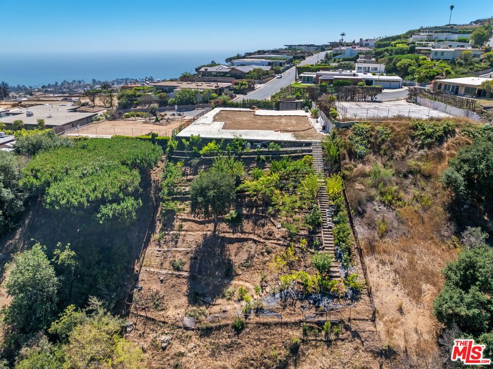 "Where Life Rises Above It All". Wake up each day to a horizon where the ocean melts into the sky, the city glimmers in the distance, and quiet canyon breezes welcome the morning. This rare 28,211 sqft parcel isn't just land, it's a canvas for your dream. From sweeping ocean views of the Queen's Necklace to the sparkle of downtown Los Angeles at night, every glance out your window tells a new story. With Phase 2 complete, beautiful front privacy gate and fence remain intact, the path to creating your dream home is wide open. This is more than a rebuild, it's a rebirth. A chance to live not just in a house, but in a vision that reflects you. Be part of the renewal. Be part of what's next.