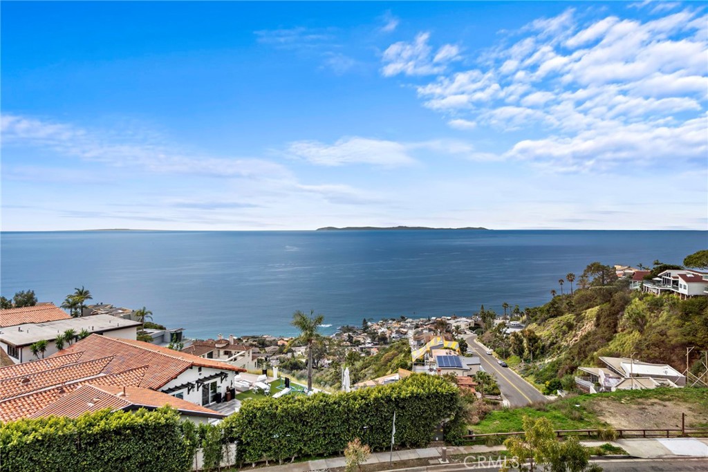Freshly updated custom-built home offers an incredible 180-degree unobstructed ocean and coastline view stretching from Long Beach to Dana Point. Boasting three bedrooms and two and a half bathrooms across over 2500 sq ft of living space, the home features unobstructed views throughout. Recently remodeled kitchen and baths showcase new appliances, while the two-car garage provides direct access. A front and side brick courtyard, along with a kitchen center island and stainless appliances including a double oven, trash compactor, and dishwasher, enhance the living experience. The kitchen also opens to a patio ideal for barbecuing and outdoor dining, complemented by a pass-through laundry area with pantry space. The dining area is separate from the spacious living room, which boasts walls of glass and a family room with a wet bar. Two decks, one on each side of the house, offer additional outdoor space, and a fireplace adds warmth to both the living and family rooms. A powder room is conveniently located on the main level. The master suite impresses with a fireplace and unobstructed ocean views, including Whitewater views and Catalina Island, along with a large walk-in closet and a spa bathroom featuring a separate tub and shower, as well as a makeup area, all with ocean views. The upstairs hosts two bedrooms, one with a larger linen cabinet and a brand new beautiful bathroom with a shower in the hallway, serving bedroom with ocean views. Another smaller bedroom also utilizes the hall restroom with built-ins. Conveniently located within walking distance to parks and hiking trails, this home offers a serene coastal lifestyle.