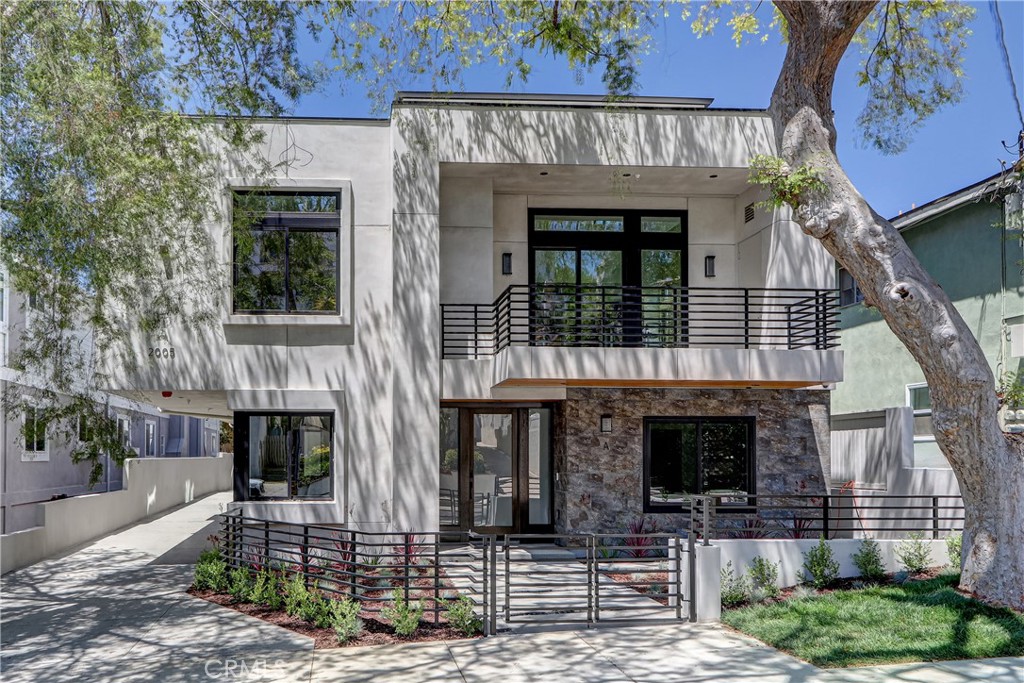 Located in a very desirable area of North Redondo Beach, this front-unit townhouse offers a bright and inviting atmosphere with an abundance of natural light throughout the home. A beautiful tree sits just outside the house, providing a serene view and a charming touch to the curb appeal. One of the standout features is the expansive mezzanine deck with a balcony—an incredibly versatile space that functions like a media room, office, or playroom, perfect for both relaxation and entertainment.
Home features a gas fireplace in the living room, solid core interior doors, and 9 ¼-inch wide white oak hardwood flooring. Throughout the home, you’ll find 4-inch LED recessed ceiling lights and a full fire sprinkler system.
The kitchens are designed with islands, quartz countertops, tiled backsplashes with concealed appliance outlets, and high-quality cabinetry constructed with plywood boxes and soft-close metal drawers. Custom mirrors and designer light fixtures complement the contemporary finishes, along with Hansgrohe faucets and a Thermador stainless steel appliance package—including a gas range, French door refrigerator, dishwasher, and microwave drawer.
Home includes a dedicated laundry room with a sink and side-by-side hookups for washer and dryer. Comfort is ensured with forced air heating, central air conditioning, and an energy-efficient tankless water heater. Unit has 2 car garage with one guest parking space and equipped with solar panels and Andersen windows.
For added peace of mind, the home is outfitted with a smart security system featuring motion detectors, exterior cameras, and a doorbell camera, all of which can be controlled remotely—along with lighting, garage doors, and entry doors—via home automation. Coaxial and CAT 6 wiring leads to a central media hub, and all utilities are installed underground for a clean and efficient infrastructure.