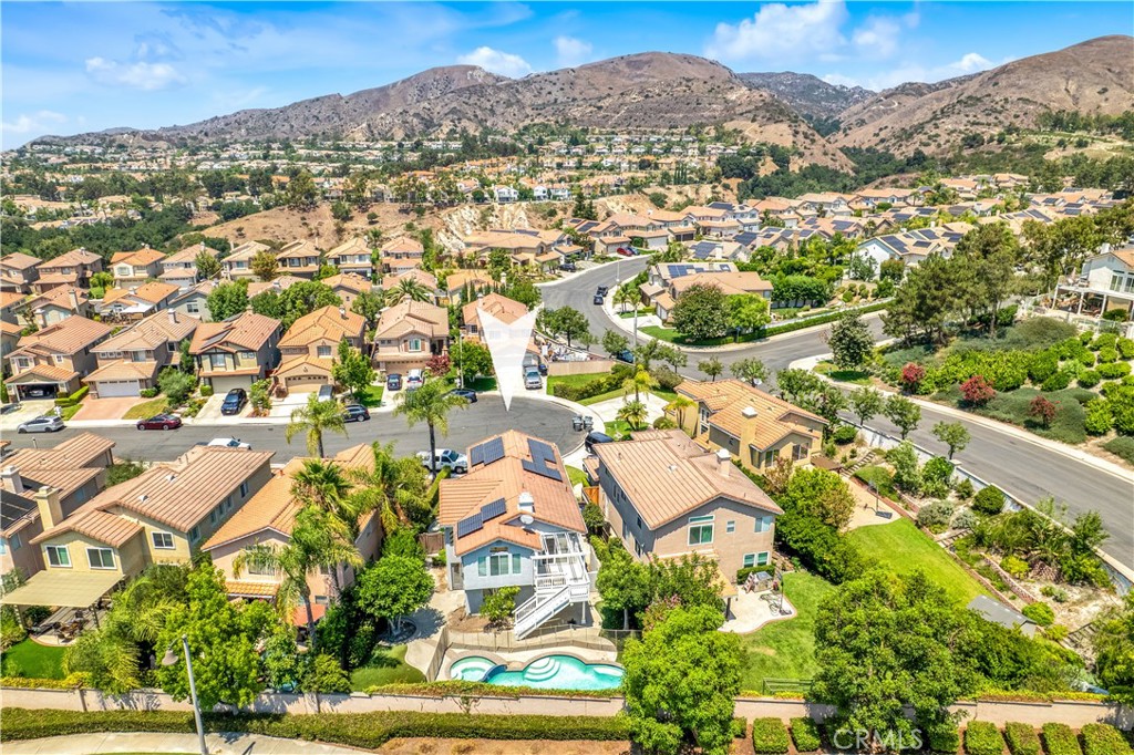 Lease the good life at 6 Tavella! Tucked away at the end of a quiet, kid-friendly cul-de-sac in the highly desirable Trieste Community of Foothill Ranch, this absolutely stunning POOL HOME offers exceptional privacy, fantastic outdoor space, and an unbeatable location. With 4 bedrooms, 2.5 bathrooms, and 1,902 sq ft of living space, this home features a functional floor plan, soaring ceilings, and separate living and family rooms for flexible living space —all situated on one of the LARGEST LOTS in the neighborhood. The kitchen is the heart of the home, boasting granite countertops, stainless steel appliances, abundant cabinetry, and an abundance of natural light. It opens to an elevated deck overlooking the expansive backyard—ideal for morning coffee or evening relaxation. The spacious primary suite includes a walk-in closet with custom shelving, dual vanities, a soaking tub, and a glass-enclosed shower. Step outside to your very own resort-style backyard featuring a sparkling pool and spa, artificial turf, and the perfect amount of space for relaxing, playing, and entertaining. Additional features include central air, recessed lighting, neutral paint, SOLAR PANELS, a dedicated laundry room, and an oversized two-car garage. This pet friendly home affords you all the perks of Foothill Ranch living — just a short stroll to award-winning Foothill Ranch Elementary, Borrego Park, and the Foothill Ranch Public Library. The community offers a wealth of amenities including a pool, spa, clubhouse, parks, tennis and sports courts. Outdoor enthusiasts will love nearby Whiting Ranch Wilderness Park with its scenic hiking and biking trails. With easy access to shopping, dining, theaters, and the toll roads, 6 Tavella truly offers the best of indoor-outdoor living. Don’t miss this rare opportunity!
