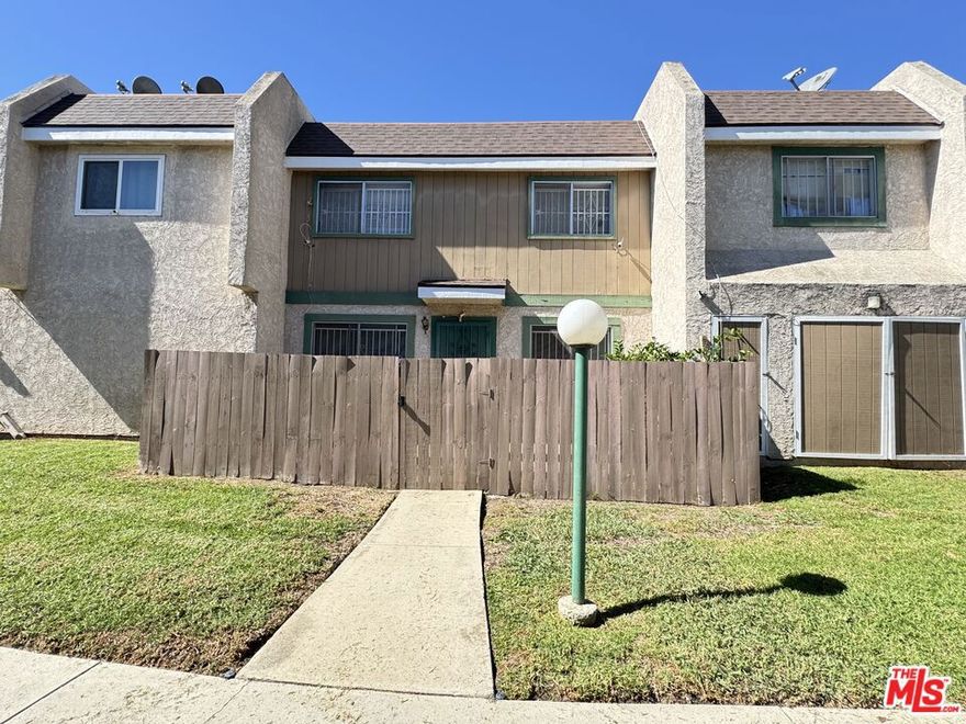 Vacant and available, 2+2 condo unit, looking for a bit TLC, presenting a great opportunity for you to bring your interior designer's touch.  A private fenced cozy patio welcomes you, with space to have a small vegetable garden, next to a matured lemon tree.  The Metal door entrance is waiting for your personal touch, as well as the carpet, waiting to be replaced with modern flooring of your taste.  The bright kitchen, with pocket door,  awaits your energy-efficient stainless-steel appliances.  On the first level you'll find a dining area with large mirrored-wall next to the kitchen, a large living room space, a bathroom with washer and dryer hookups, as well as a coat closet or storage space.   The upstairs features two bedrooms and a full size bathroom.  There is a detached two car garage just a few steps away from the unit and a community pool.  Please call or text to schedule a showing.  SOLD AS IS.