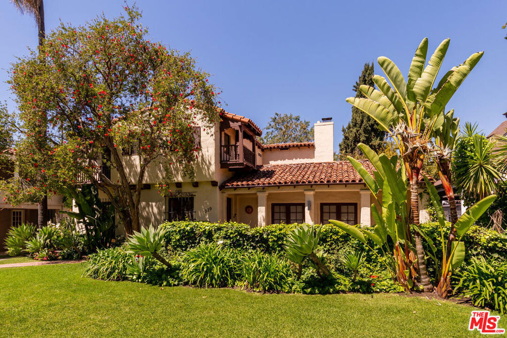 1920's Spanish-style residence with generous front porch, in renowned Hancock Park! A perfect blend of authentic character and designer redone kitchen and baths. Formal entry into a dramatic foyer with a graceful winding staircase and decorative wrought iron. Beautiful tile and polished hardwood floors flow throughout. Spacious cathedral-ceiling living room featuring exposed beams and a big fireplace. Soft recessed lighting enhances the warm ambiance. Large dining room capable of accommodating intimate or grand entertaining. Four good sized bedrooms and three and a half tastefully renovated bathrooms. Elegant primary suite offers an expansive walk-in closet and a luxurious ensuite bathroom. Additional space upstairs suitable for an office or playroom. Convenient maid's quarters, additional bathroom, and bright breakfast room. The Modern chef's kitchen is large with a generous center island and abundant storage. Separate laundry room. Serene, lush green yard is like a park with a beautiful mature Elm tree and complete privacy. Rear garage now finished as an office, gym, or playroom with yet one more smaller room both with separate entrances. Outdoor deck accessible from the kitchen and the living room provides intimate space for outdoor entertaining and dining. Equipped with a Ring security system, electric vehicle charging station, and alarm system. For lease for long term only 13 months minimum.