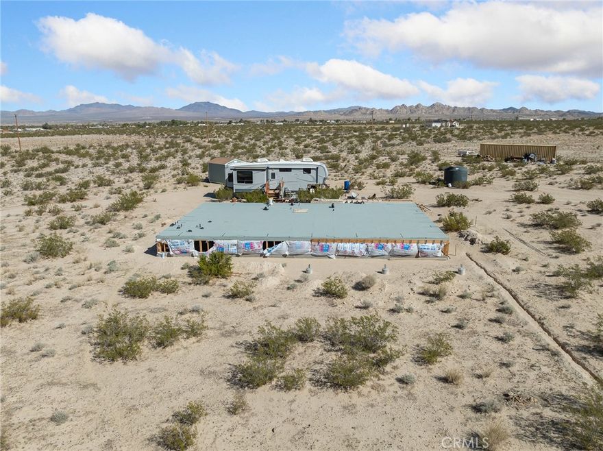 Here’s your chance to bring your dream home to life on 2.14 acres of peaceful, open land in Lucerne Valley! The raised foundation is already in place, making future plumbing repairs simple and accessible. Rough plumbing is installed, ducting is in, and pipes are insulated, so much of the hard work is already done. The well is connected to an approximate 3,000-gallon holding tank, which currently provides water to the RV and is prepared to run water to the home. Power is already connected to the well and has been run underground. You will receive the plans for a 1,655 square foot two-bedroom, two-bath home, and the seller will provide an updated inspection to keep them active. The property is fully fenced and includes a 10 by 12 shed and a 40-foot storage container for all your tools and materials. A percolation test has been completed, so the property is ready for septic installation. The RV can also be negotiated for an additional cost, giving you a comfortable place to stay while you bring your dream home to life. Do not miss this opportunity to create your perfect home! Schedule a showing today!
APN# 0449-222-13-0000