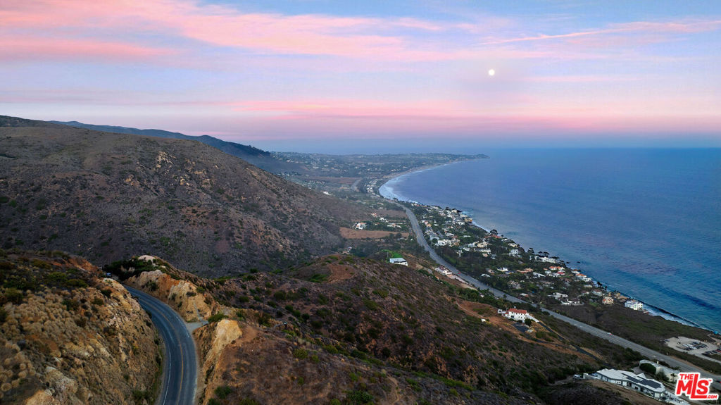 UNMATCHED LAND OPPORTUNITY IN WESTERN MALIBU. Perched high above the Pacific Coast Highway with commanding, unobstructed 180 views from iconic Point Dume to majestic Point Mugu, this 2.38 acre parcel offers an extraordinary opportunity to build a dream estate overlooking the pristine Encinal Bluffs. Sold with a full suite of entitlements and near-complete permits, the property includes CITY OF MALIBU APPROVED COASTAL DEVELOPMENT PERMIT (CDP) that is valid until June of 2026, by which time valid construction must commence. The 95% completed Planning and Building approvals, have begun to pave the way for a streamlined path to construction. Iconic design collaboration between Studio Ermacora and California modern Architecture Studio Marmol Radziner, the Villa concept provides a combination of outward looking striking vistas while being utterly secluded and aiming to invite a sense of inner peace. AIA envision a striking 5,000 sq ft contemporary residence featuring:*3 spacious bedrooms and 3.5 baths*Seamless indoor-outdoor flow with expansive decking and pool*Attached 2-car garage*Thoughtfully integrated landscaping*Onsite wastewater treatment system with seepage pit dispersal. Significant infrastructure is already in place, including a 1,200-foot deep well and two 10,000-gallon water tanks, ensuring robust water access. Sale includes a comprehensive set of plans and reports: *Site plan with setbacks *Access and grading plans *Slope analysis and erosion control plans *Soil, drainage, and geological reports *Biological and archeological assessments *Survey and topo map *Fire Department and Building & Safety approvals This rare offering combines breathtaking views, significant pre-development investment, and world-class design pedigree ideal for a discerning buyer ready to create a signature Malibu estate.