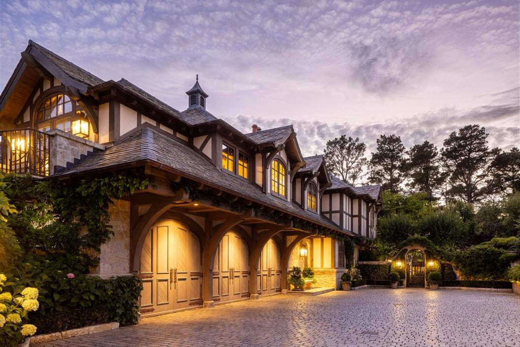Nestled on a stunning hillside amid magnificent gardens, this luxurious property is the result of meticulous planning and craftsmanship, culminating in an impressive eight-and-a-half-year build. Every detail has been thoughtfully considered, from the hand-carved limestone fireplaces and intricate masonry to the fumed French oak floors and hand-hewn beams. Adorned with Jan de Luz antiques throughout, the landscape is a masterpiece of elegance, featuring Koi ponds, fountains, and granite reclaimed from France, all seamlessly integrated to create a timeless atmosphere that feels as if it has existed for a century. Additional features include a custom wooden three-bay garage, a separate guest house, a beautiful glass atrium, over 40 hand-picked varietals of fruit trees, an elevator, a silver closet, a game room, and an outdoor kitchen. The house is equipped with air conditioning, a generator, an in-ground custom spa and Cal-Am water. Just a short drive from the incredible attractions of Pebble Beach, Carmel, and beyond, this estate embodies a harmonious blend of art, design, and functionality. It is a testament to the passion and precision of the experts who crafted this home, resulting in unparalleled beauty and elegance.