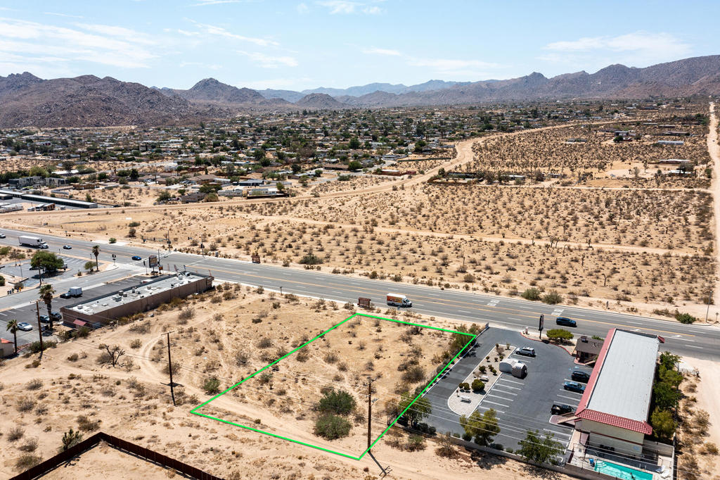 Prime location west of Park Blvd! Turn-key commercial zoned lot. Top value highway frontage visibility in world famous Joshua Tree. Over 1/2 an acre with utilities in the street. Alley access in back for deliveries or more. Initial reports completed including survey with markers, soils and environmental review. The opportunities are endless. Possibly uses may allow restaurant, bar, hotel, offices, art gallery, flex-space, religious facility, and more. High visibility. Less than 6 miles to the Joshua Tree National Monument main gate. About 3 million tourists visit the park annually. Very hot vacation rental area. The recent trend in tourism has transformed the greater area into a hip getaway destination. 33 miles to Palm Springs. 126 miles to Los Angeles. Buyers must contact the county planners for all questions on building and usage. Buyers must contact the appropriate utilities agencies for all questions on utilities. Lot lines approximate, property has a setback from the hwy. (APN) 0602-371-14-0000 Address is assigned. Don't Wait! - Call Now!