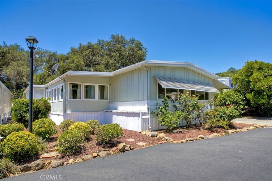 Nestled in the heart of the serene and picturesque Oak Crest Estates, this charming 3-bedroom, 2-bathroom manufactured home offers a perfect blend of tranquility, modern comfort, and community living. Spanning approximately 1,200 sq. ft., this inviting residence is situated in a 55+ co-op, land-owned community, providing an affordable and vibrant lifestyle surrounded by Fallbrook’s breathtaking natural beauty. Step into a light-filled, open-concept living space designed for comfort and relaxation. The spacious living room flows seamlessly into a formal dining area, ideal for entertaining guests or enjoying quiet evenings at home. The well-appointed kitchen boasts ample cabinetry and a functional layout perfect for preparing meals with ease. The primary suite features an en-suite bathroom for added privacy and convenience. The second bathroom is tastefully updated, offering a tub/shower combo. Additional highlights include newer flooring, double-pane windows, central heating and air conditioning, and a washer/dryer for in-home laundry. Outside, a covered carport accommodates two vehicles, and a storage shed provides extra space for gardening tools or seasonal items. The low-maintenance lot is adorned with native landscaping, complementing the community’s commitment to preserving the natural surroundings.
Community Features Oak Crest Estates is a hidden gem, offering an unparalleled living experience for those seeking a peaceful yet engaging retirement. Spanning over 8.5 acres of lush, oak-lined land, this 55+ co-op community fosters a strong sense of camaraderie and pride among residents. The low HOA fees ($494/month) cover essential utilities, including water, sewer, and trash, making homeownership both affordable and hassle-free. Residents enjoy access to a wealth of amenities, including:  Clubhouse: A hub for social activities, featuring a recreation room, billiards/card room, and a cozy library for quiet relaxation.  Heated Pool & Spa: Perfect for unwinding or staying active, the pool and spa are maintained to resort-like standards.   Walking & Hiking Trails: Scenic trails wind through the community, offering stunning views of majestic oak trees, seasonal streams, and dramatic rock formations.  Community Garden: A space for green thumbs to cultivate their own produce or flowers, fostering a connection to nature.  RV Parking & Car Wash Facility: Convenient amenities for road-trippers and vehicle maintenance.