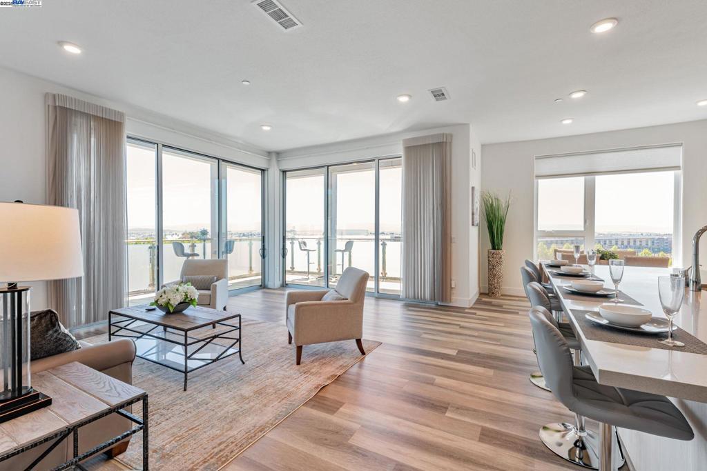 Penthouse Living, Natural Light! Wall of Windows. Wrap around Balcony, Views of Fremont, Milpitas, and San Jose Hills. Warm Springs BART a stones throw away. Model Home Living. This spacious single story has it all, well appointed through out. Open concept layout- kitchen, family room, dining room combination. Absolutely perfect for Entertaining! Resort style living, Wrap around Balcony, enjoy indoor and outdoor living exclusively. Privacy at its finest! Split floor plan- Primary suite boasts walk in closet, dual sinks and expanded walk in shower. Second bedroom suite is ideal for kids or office. Third oversized bedroom is situated away from living area and other bedrooms, perfect for quests or multi generational living. Additional features include recessed lighting, remote control blinds, A/C, inside laundry, storage space, Secure Garage Parking 2 Spaces with private EV charging station. ( next to entrance of building) Residents enjoy access to resort style amenities include fitness center, pool and spa, Clubhouse, outdoor BBQ areas, and beautifully landscaped courtyard, walking paths and sitting areas. Close to all freeways, Mission Peak, various walking trails, shopping and dining. The new Washington Hospital, minutes away. Close to all major Technology Companies! A must see!!