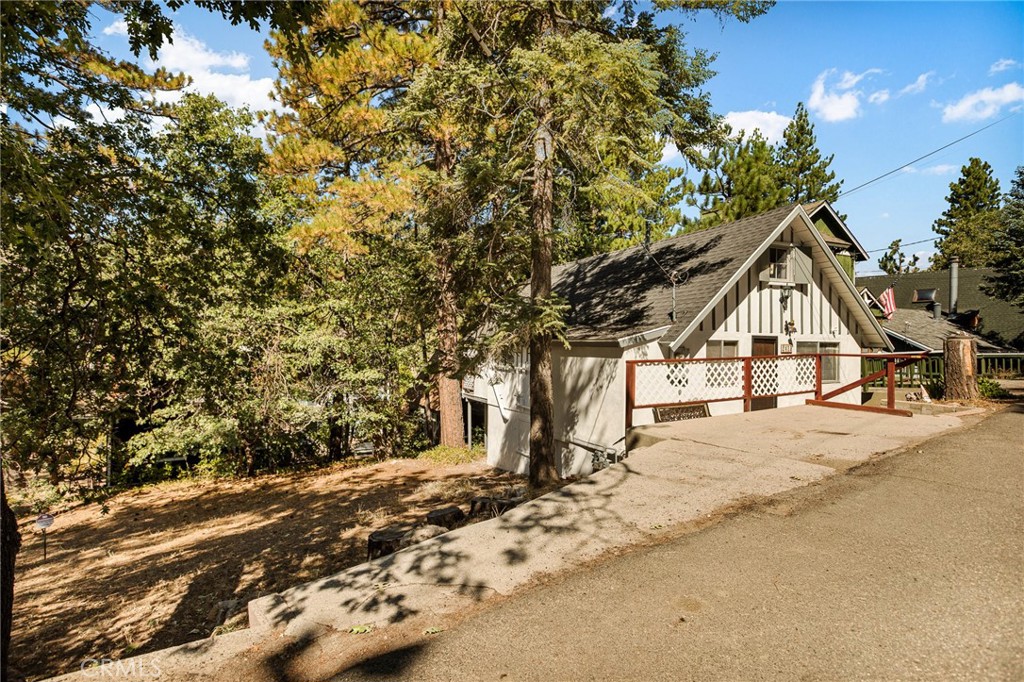 Nestled amidst the picturesque community of Arrowbear, this timeless gem might just steal your heart like it did the current owners many years ago! This 1927 charming cabin comes with the lot next door adding extra space and privacy. Maybe you want to fence the entire property, build another house, an ADU, a large parking area, or whatever your heart desires, the extra space adds for extra possibilities. This home shows true pride of ownership and offers comfort, character and the true mountain lifestyle. Your mountain adventures begin here, with year-round enjoyment, located close to national forest hiking trails, Snow Valley, Running Springs, and even Big Bear. There are two bedrooms, with one on the main floor, and a generously sized loft/style bedroom upstairs. There is a stackable washer dryer inside and you won't want to miss the large basement/storage area with access from inside the home. The back deck is a great spot to admire the soaring pines trees. You won't want to miss this one, and it comes furnished minus sellers personals. This could be the perfect starter home, full time home, or part time home. The potential is endless.