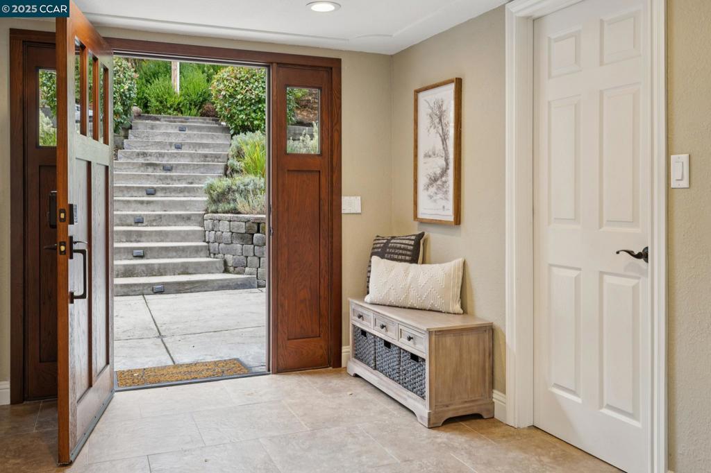 Nestled on a quiet street in Alamo’s desirable Westside, this remodeled custom home blends luxury and comfort. The stainless and granite chef’s kitchen shines with a Viking range, pantry and wine refrigerator—perfect for everyday living or entertaining. Hardwood floors, cathedral ceilings, skylights and Anderson windows add warmth and sophistication throughout 3,100+ square feet of open architecture. The main level offers effortless living with 2 bedrooms and 2 baths, including a level-in entry and a private, spacious patio. The tranquil primary retreat features a glass shower and jetted tub, while a separate wing provides 2 additional bedrooms with a Jack and Jill bath. Outdoors, enjoy a serene oasis with a refinished pool, newer pavers and a lush green landscape, perfect for entertaining or relaxation. A spacious dog run with low-maintenance turf enhances functionality. Peaceful and private, this home is tucked back on a private lane backing to the Iron Horse Trail—just 0.9 miles from Murwood Elementary and near WCI and Las Lomas High, all top-performing schools. Owned solar completes this exceptional offering at an equally exceptional value.