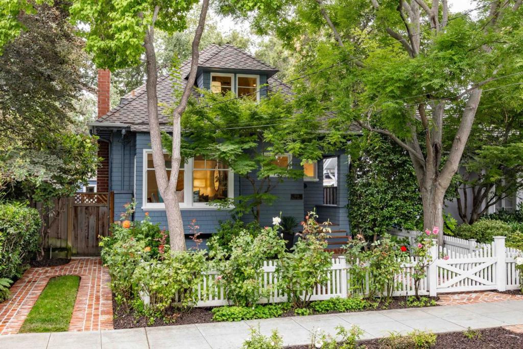 Tucked behind a white picket fence on a tree-lined street in the Professorville neighborhood, this charming home pairs more than 120 years of heritage with comfortable, everyday livability. A brick path leads to the front door and into a warm, welcoming space filled with natural light, hardwood floors, and period details throughout. The large living and dining room combo is anchored by a fireplace, while the kitchen features appliances from Bosch, GE Profile, and Sub-Zero. A walk-out flexible use room provides space for an office or family room, and the bedrooms include a comfortable primary suite on the main level. Outside, a peaceful yard with a deck and patio invites easy indoor-outdoor living. All of Palo Alto is within easy reach, from the vibrancy of University Avenue to Stanford, beautiful parks, and top-rated schools Addison Elementary, Greene Middle, and Palo Alto High (buyer to verify eligibility).