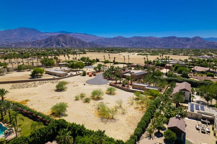 Located beyond the impressive entry gates of Indio's intimate Croquet Court collection, this flat, buildable homesite spans more than one acre, providing ample room for the custom home that you have always dreamed of creating. Surrounded by upscale estates in a quiet setting with mountain views, the sprawling lot offers a prime position at the end of a cul-de-sac in the established neighborhood, which currently features 15 completed residences and just a few remaining homesites. There are no short-term rental restrictions at Croquet Court, and the HOA fees are only $250 per year. The Empire Polo Club, which hosts the annual Coachella Valley Music and Arts festival and the popular Stagecoach Festival, is just minutes away, providing a tremendous source of short-term rental income for the area. With the potential to generously accommodate a spacious, fully appointed custom home complete with a resort pool, spa, outdoor kitchen and more, the lot is embellished with one existing block wall, an established oleander hedge on two sides that enhances privacy, and views that will not be compromised by future development on the parcel to the west. A natural gas connection is available, a water well is possible for irrigation, and municipal water and septic are featured. Just off 49th Avenue, known as Indio's Golden Mile, Croquet Court is south of Highway 111 yet close to dining, golf, entertainment, Old Town La Quinta, casinos, major retailers and vibrant shopping centers.
