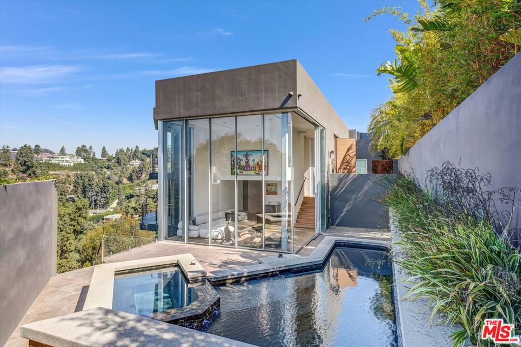 LEASE WILL BE AVAILABLE ON THE 21ST SEPT .... A Beverly Hills Masterpiece with Unrivaled ViewsPerched at the very top of prestigious Readcrest Drive in the world-famous 90210one of the most desirable zip codes on the planet, this gated, architectural showpiece offers an extraordinary blend of style, privacy, and panoramic beauty. Renowned for having the best views in Beverly Hills, this home captures a breathtaking tapestry of ocean, city lights, and rolling canyon hills, all the way to the horizon. A dramatic contemporary statement, the residence is glass-gated and serenely tucked away on a quiet cul-de-sac in the exclusive enclave of The Crests. Floor-to-ceiling windows dissolve the boundary between indoors and out, flooding the space with natural light and framing jaw-dropping vistas from nearly every room. High ceilings and crisp white gallery walls create a museum-quality setting for art, while blonde hardwood floors and stainless steel accents infuse warmth and modern sophistication. The resort-style backyard is an entertainer's dream featuring a cascading waterfall pool and spa, sun-drenched decks, lush lawn, and even your own basketball court. Meander through the grounds and you'll find lemon trees adding a fragrant, Mediterranean touch to the property.Inside, the home offers a luxurious primary suite with loft lounge or office, two additional bedroom suites, a media room, home gym/office, wine cellar, and a rare professional photo darkroom. Designed by celebrated architect Rex Lotery in 1959 and later expanded and reimagined for the modern era, this home is as much a work of art as it is a residence complete with celebrity ownership history and top-tier security, audio, and lighting systems.In a location of unmatched prestige, with million-dollar views in every direction, this is Beverly Hills living at its most spectacular.