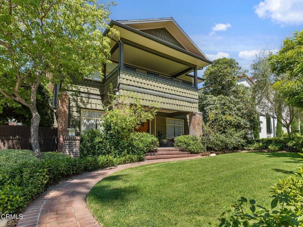 This 1924 Craftsman situated in the Casa Verdugo Historic District is a masterpiece. Follow the red-brick pathway across the impeccably landscaped front yard to the front porch, replete with porch swing. Enter into a large living room with original oak hardwood floors, 9-foot ceilings, extra-wide crown molding, picture windows, a Batchelder fireplace, and built-in cabinets. The formal dining room has a stunning built-in buffet with beveled glass cabinets, plenty of storage and stunning mahogany pocket doors. The breathtaking kitchen was completely redone in 2014 and spared no expense. It features a prominent white quartz island that includes a Wolf induction cooktop and retractable downdraft vent; ample custom-built cabinetry with soft close drawers, a built-in pantry, an appliance garage and an integrated SubZero fridge and freezer; a stainless steel dishwasher, a Wolf Electric Convection oven and a Wolf Electric Steam Oven. Alongside the kitchen is an informal eating area with French doors that open out onto a spacious deck/pergola for indoor/outdoor dining entertainment. Through a pocket door in the kitchen is a mud/laundry room with stacked LG Thinq washer/dryer and an integrated cabinet with folding counter, hamper, hanging rod and storage. Upstairs, the primary suite occupies the front half of the house with a spacious bedroom and sleeping porch; a full bathroom with Calacatta Gold hexagonal marble tile, wainscoting and custom lights; a seamless glass shower; porcelain enameled cast iron clawfoot bathtub and a custom stained hardwood vanity. Nearby is a spacious walk-in closet with custom designed built-ins including shoe cubbies, drawers, an extensive wardrobe and overhead storage. On the other end of the 2nd level are two sizable bedrooms and a full bathroom featuring charming scallop tile, custom vanities, and a large double sink. The backyard is an oasis: a patio area with a custom-built gas fire pit; a poolside lounging area and custom daybed; a putting green and practice net; a play area with an elaborate playhouse and swing set, a Salem Barrel sauna and a Renu cold plunge. Inside the partially converted garage is an office/exercise room with a Tonal home gym system. The property also boasts a 23 panel 8.4kw solar panel system to help offset rising energy prices. Ideally located near Brand Park, Nibley Park, downtown Glendale and highway 134. Your search is over; this is your dream house come true!