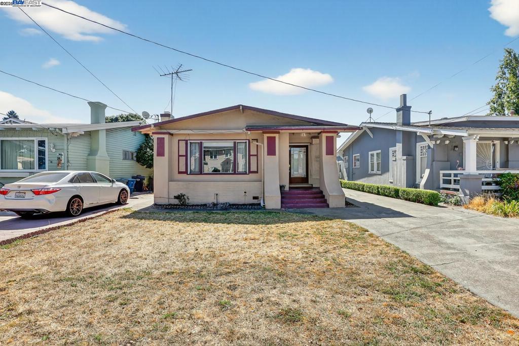 Welcome to a piece of San Leandro's story on the tree lined Sunnyside Drive! This 1923 built treasure features a craftsman -style home that offers three good size bedrooms, one bath and 1226 square feet of living space! A large rock wood burning fireplace greets you in the living room. Open dining area and original hardwood flooring throughout the house. Cozy kitchen with a side door access to backyard. This home home is all wrapped in character and poised for a update if you wanted to. The generous huge 7200 sq foot lot invites many possibilities: a dreamy garden retreat , additional living space enough for a good size ADU, or nice large entertainers oasis. A convenient detached oversized garage, workshop and a separate bonus room next to garage! Oh and do not forget the long driveway that leads to this wonderful garage.Whether you're drawn to restoring original charm or envisioning a contemporary redesign, this home provides a thoughtful canvas. Located within walking distance to schools, parks, transportation, local favorites, coffee shops, eateries and easy commuter access via BART and nearby freeways. - this property blends lifestyle and convenience in one inviting package.