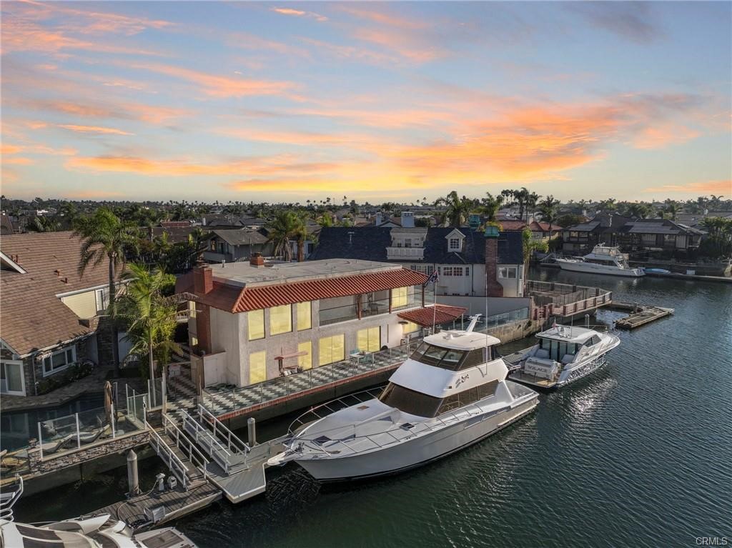 Experience the ultimate in coastal luxury with this exceptional Huntington Harbour estate, gracefully set on a rare triple lot with 120 feet of prime waterfront. With 4,077 sq. ft. of newly renovated living space on a 6,500 sq. ft. parcel, this home was designed for those who demand the very best.
A complete top-to-bottom renovation in 2022 brings a modern, sophisticated touch to every corner—featuring a gourmet kitchen with new cabinetry and appliances, all-new designer bathrooms, and spacious open living areas ideal for entertaining. The residence offers 4 bedrooms, 4.5 bathrooms, and a dedicated office, giving you both comfort and functionality.
Resort-inspired amenities set this home apart: enjoy your own indoor jacuzzi room, relax in a private sauna, or unwind in the sparkling pool surrounded by serene water views. Boaters will appreciate the newly rebuilt 110-foot private dock—your personal launch point for ocean adventures, from day trips to Catalina Island to sunset cruises along the coast.
Nestled at the end of a quiet cul-de-sac, this residence offers unmatched privacy with the freedom of no HOA restrictions. Just minutes from Huntington Harbour Plaza, Harbor View School, and Mother’s Beach, convenience meets exclusivity in this one-of-a-kind location.
From panoramic views to hosting friends for the famous Huntington Harbour Boat Parade, every day here feels like a getaway.
Don’t miss this rare opportunity to claim your slice of waterfront paradise. Schedule your private showing today.