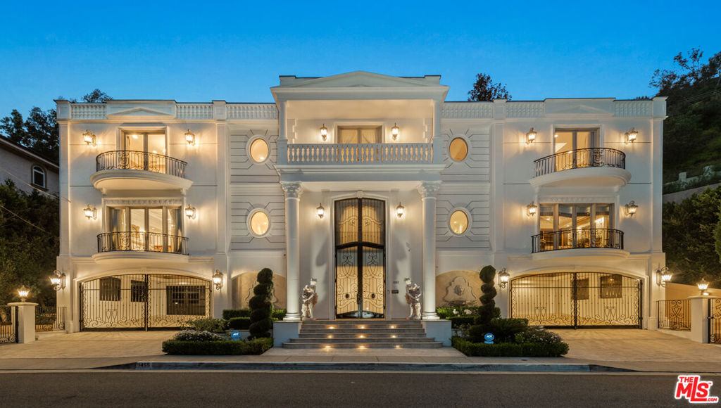 Welcome to a world of timeless grandeur and refined elegance in this spectacular French Colonial estate, originally envisioned to host diplomats and royalty with the utmost discretion and comfort. Nestled on prestigious Robmar Drive, just moments from the pulse of Beverly Hills and iconic Rodeo Drive, this palatial residence offers an unmatched lifestyle of luxury and sophistication. With 5 bedrooms and 8 bathrooms, the home welcomes you with a dramatic double-height foyer, where sweeping twin staircases with ornate wrought-iron railings ascend beneath a magnificent chandelier. The main level is anchored by a lavish great room perfect for entertaining on any scale. The gourmet kitchen is a chef's dream, complete with sculpted marble countertops and a charming breakfast nook. Adjacent, the formal dining room is accented by a hand carved marble fireplace, while the family room offers a warm ambiance with a custom hardwood entertainment center and additional fireplace. The stately library impresses with a richly detailed coffered ceiling, fireplace, and custom-built bookshelves and cabinetry. Upstairs, the expansive primary suite is a true sanctuary, boasting both a luxurious sleeping chamber and an elegant sitting room each with its own fireplace. The oversized walk-in closet features custom hardwood cabinetry and a central island, while the spa-like primary bathroom includes dual vanities, dual showers, a soaking tub, and exquisite inlaid marble flooring. Three additional en suite guest bedrooms offer comfort and privacy for family and visitors alike. Thoughtfully designed for both beauty and functionality, the home is served by an elevator and adorned with polished marble and inlaid hardwood flooring, hand-painted ceilings, charming chandeliers, French doors, balconies, and opulent window treatments throughout. Outdoors, a serene private patio leads to a lush lawn, sparkling pool, and relaxing spa, all set against a terraced hillside of mature landscaping with fruit trees. The lower level completes the estate with a state-of-the-art gym, a professional-grade screening room, and a crescent-shaped, dual-gated motor court for secure, stylish arrivals. Meticulously maintained, this architectural masterpiece is a rare offering providing privacy, prestige, and proximity to the best shopping, dining, and entertainment in the world-renowned city of Beverly Hills.
