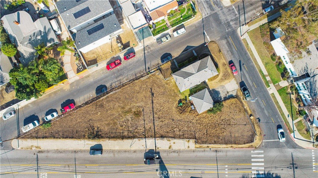 Introducing two contiguous parcels comprising a unique 14,493-square-foot triangular lot with unmatched potential, situated on high-traffic Anaheim Street with frontage on all three sides. This exceptional property is strategically positioned for maximum visibility, making it perfect for commercial development or mixed-use projects. Passed down through generations, it is now being offered on the market for the very first time, presenting a truly unique opportunity. Currently, the lot features a duplex with two one-bedroom units and a two-car garage, offering immediate rental income while you plan your next move. Utilities are already on site to streamline the development process, adding convenience for future projects. Zoned LAC1.5, this property provides the flexibility for a variety of commercial and residential uses, aligning perfectly with the dynamic needs of the area. Situated in a bustling corridor surrounded by thriving businesses and vibrant residential communities, this location benefits from consistent vehicle traffic. Proximity to retail, dining, and public transit further enhances its appeal, making it an attractive destination for future tenants or customers. With its high traffic count and strategic location, this lot is a rare find, offering both significant development possibilities and unparalleled accessibility. Don’t miss this opportunity to transform a prime piece of real estate into a thriving enterprise.