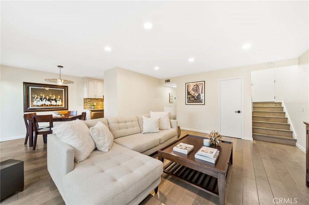 Step through the double front doors into this beautifully updated Lomita Pines townhome, where bright and airy living meets thoughtful design. The main level features a spacious living room with an oversized sliding glass door that opens to a private patio with direct greenbelt access, creating seamless indoor-outdoor flow and endless potential for outdoor living. The modern kitchen is appointed with granite countertops, custom cabinetry, stylish tile backsplash, stainless steel appliances, and recessed lighting, while a convenient half bathroom and the flexible downstairs office with a closet is easily converted into a fourth bedroom with the addition of a door. Upstairs, you’ll find three bedrooms and two full bathrooms, including a large primary suite with a walk-in shower and new glass door. Throughout the home, upgrades include luxury vinyl plank flooring, remodeled bathrooms, crisp white shutters, dual pane windows, and new central air and heat.. A two-car garage offers ample parking and storage. The Lomita Pines community is admired for its mid-century modern architecture, tranquil setting, and greenbelt that spans Palos Verdes Drive North, offering two pools, a basketball court, and a clubhouse. Strategically located at the gateway to the Palos Verdes Peninsula, this home is close to shops, coffee spots, beaches, freeways, waterfront attractions, and scenic horse and hiking trails, making it the perfect balance of convenience and lifestyle.