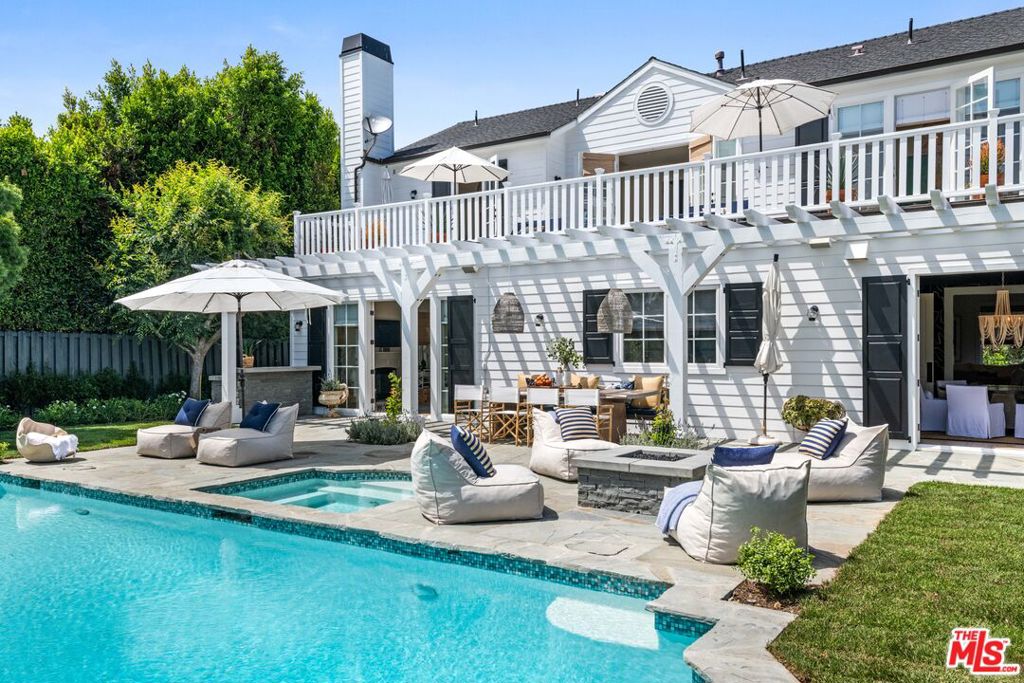 Elegant and impeccable, this traditional Cape Cod home sits at the end of cul-de-sac in a gated community on Point Dume with beach key access. The gourmet chefs kitchen has been designed and outfitted by Clive Christian. French doors seamlessly open the kitchen and living room to a trellis covered outdoor dining and sitting area. The professionally landscaped back yard is an entertainers dream with a large pool, rose gardens and built in bbq and fire pit. The interior features high beamed ceilings, hardwood floors, and windows and decks that overlook the manicured grounds. The interior rooms are categorized by a formal living room with fireplace, formal dining room, sun-filled family room with fireplace gourmet kitchen with chandelier island, Calcutta marble countertops, breakfast/lunch dining area, and custom designed office/bedroom. Upstairs landings open onto full-width deck overlooking the gardens. There are three bedrooms all decorator designed with an owner's suite with a private deck and a spa style bath with custom closets and marble floors, plus two additional bedrooms. Detached is a two-car garage with built-in storage and guest parking.