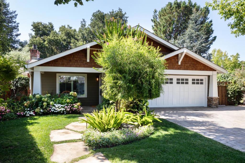 Resort-style living unfolds at this beautiful Craftsman home ideally located at the end of a cul-de-sac in Midtown. The interiors are filled with natural light and defined by extensive millwork, including tall wainscot and custom built-ins. The floor plan is wonderfully flexible for both formal and everyday living and dining, along with 4 bedrooms and 2 offices perfect for todays remote work needs. At the center of the design is a gourmet kitchen with premium appliances and towering skylights. The spacious primary suite includes a private office or fitness area and convenient direct access to the outdoors. The surrounding setting is truly special with a resistance jet pool and spa backed by a waterfall wall, a spacious patio with outdoor media screen, and lush gardens filled with roses, hydrangeas, and fruit trees including a beautiful and majestic olive tree. Solar power, central air conditioning, and access to top Palo Alto schools add exceptional convenience to this inviting retreat.
