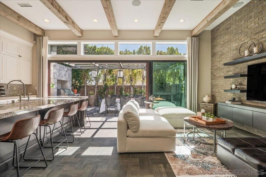Location, Location, Location !!! Just 10 minutes from the ocean, this Toll Brothers model home is a rare gem in the heart of Carlsbad. This luxurious residence has been thoughtfully upgraded throughout to offer a lifestyle of elegance, comfort, and sophistication. Step into the grand entryway with soaring 20-foot ceilings that create a sense of openness and architectural drama. The formal dining room and chef-inspired gourmet kitchen flow seamlessly into a spacious great room with 12-foot ceilings and abundant natural light ideal for both relaxing and entertaining. Accordion-style stacking doors open to a private outdoor oasis, blending indoor and outdoor living. From the great room and the first-floor master suite, step into a serene backyard retreat featuring a spa perfect for unwinding under the stars. Upstairs, a generous loft with custom built-ins provides flexible space for a media room, home office, or lounge. The layout is designed to offer privacy for guests while maintaining a warm and welcoming atmosphere. Additional highlights include paid-off solar panels, dramatic ceiling heights, and a refined open-concept design that elevates everyday living. Nestled in a peaceful, nature-rich setting, this home offers tranquility while remaining close to top-rated schools, restaurants, shopping centers, and coastal attractions. Located within the award-winning Carlsbad Unified School District, this property is just minutes from Carlsbad High School and Sage Creek High School, making it an ideal choice for families. Your next chapter begins here.