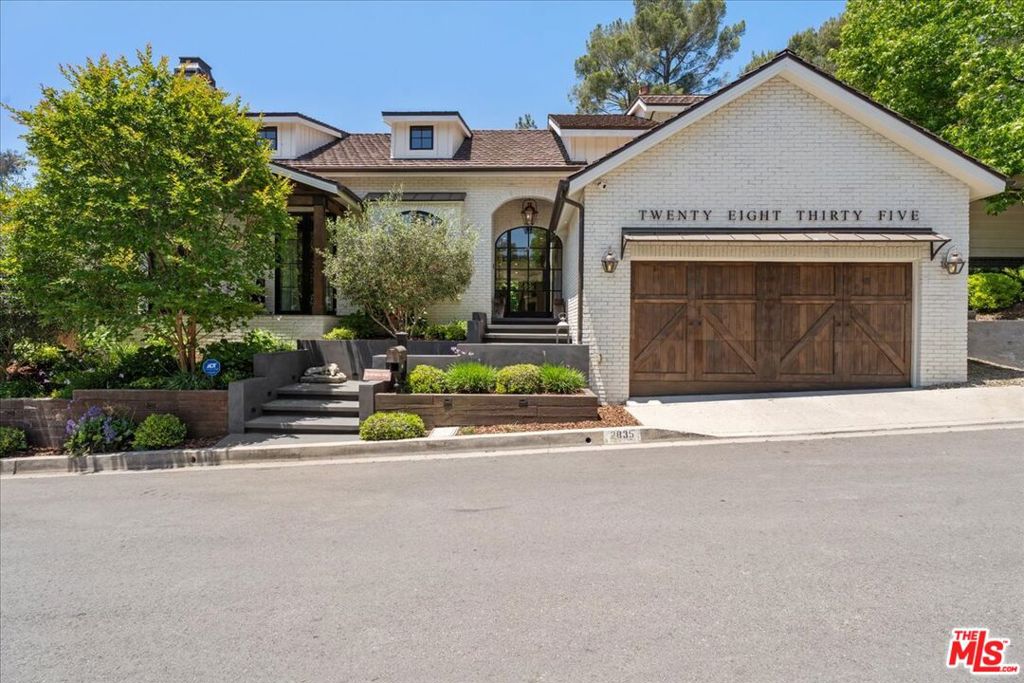Sophisticated Hollywood Hills Sanctuary Under $5 Million. This meticulously crafted 5-bedroom, 5-bathroom residence occupies a prime position on a tranquil cul-de-sac in one of Hollywood Hills' most exclusive enclaves. The home seamlessly blends rustic warmth with contemporary sophistication, creating an atmosphere that feels both refined and genuinely welcoming. Architectural details define every space: floor-to-ceiling windows flood the interiors with natural light, while four distinctive stone fireplaces anchor the living areas with organic texture and warmth. The thoughtful layout facilitates both quiet daily living and effortless entertaining, from intimate dinners to larger gatherings. Premium finishes elevate the experience throughout. Farrow & Ball custom paint creates depth and richness on every wall, while Forbes & Lomax switch plates add subtle luxury to the smallest details. The kitchen showcases top-tier appliances, including a custom beveled mirror-adorned Sub-Zero double-door refrigerator that serves as both function and art. The home features carefully curated antique and vintage touches throughout, including antique French limestone for the fireplace hearth, antique Tuscan farmhouse stone on the primary bedroom wall, hundred year-old reclaimed wood beams, vintage French oak flooring from the Lorraine region of France and authentic Tartan carpet from Scotland. The century-old solid reclaimed wood beams fit perfectly with the other historic and vintage elements of the home. The design philosophy balances comfort with elegance, imagine morning coffee on the porch swing, afternoon fires in cooler months, and evening cocktails at the formal indoor bar or on the expansive veranda. Each of the five bedrooms offers generous space and privacy, while the spa-inspired bathrooms provide daily retreat moments. Practical luxury extends to conveniences like direct garage access, while the home's position ensures both privacy and accessibility to the broader Los Angeles landscape. This is a residence where exceptional craftsmanship meets livable luxury, offered at a compelling price point in one of the city's most coveted celebrity neighborhoods. Buyers should independently verify all information through personal inspection and appropriate professionals.