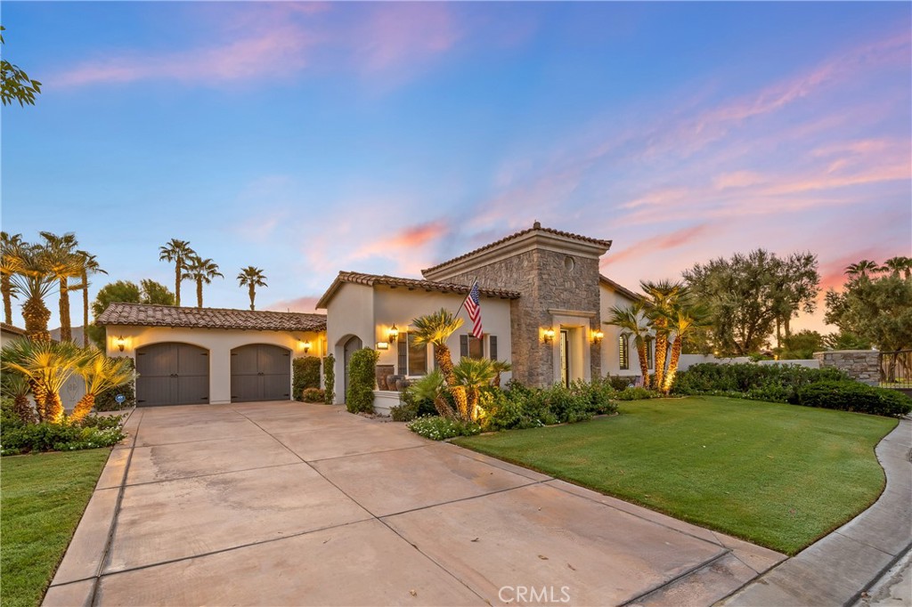 Nestled within the prestigious Norman Estates at PGA West, this meticulously maintained 3,040-square-foot home is a masterpiece of design and comfort. It offers an unparalleled lifestyle, combining modern luxury with the relaxed elegance of a resort. Every detail has been carefully considered to create a bright, airy, and inviting atmosphere, from the moment you step through the private, gated courtyard. The residence's high ceilings and thoughtfully designed open-concept layout fill every room with an abundance of natural light, creating a sense of spaciousness and tranquility. The living room serves as the heart of the home, featuring a cozy fireplace for cooler evenings and seamless access to both the front and back patios, ideal for effortless entertaining. A culinary dream, the kitchen boasts a large central island, warm wood cabinetry, and sleek granite countertops. It is equipped with top-of-the-line stainless steel appliances, including a gas cooktop, catering to the most discerning of chefs. Retreat to the secluded primary suite, which offers direct access to the serene backyard. The en-suite bathroom is a spa-like sanctuary, featuring a lavish soaking tub, a walk-in shower, dual vanities, and an expansive walk-in closet. The home includes two additional en-suite guest rooms, ensuring ultimate comfort and privacy for visitors. One is located within the main residence, while the other is a detached casita accessed from the central courtyard. The home features a very impressive custom 72 bottle wine wall for your favorite vintage. The exceptionally large backyard is a private desert oasis, complete with a refreshing pool and spa. Multiple covered and uncovered patios offer ample space for al fresco dining, sunbathing, or simply relaxing while enjoying the breathtaking mountain and sunset views. Beautifully landscaped grounds are set against a magnificent backdrop of the Santa Rosa Mountains, providing a truly spectacular setting for both relaxation and entertaining. As a resident, you will enjoy all the exclusive benefits of the La Quinta Fairways HOA, including pristine community landscaping, enhanced security, and the peaceful, meticulously maintained environment that defines this sought-after enclave. This home truly offers the epitome of upscale, single-level living in the highly desirable PGA West Greg Norman area. Welcome Home.