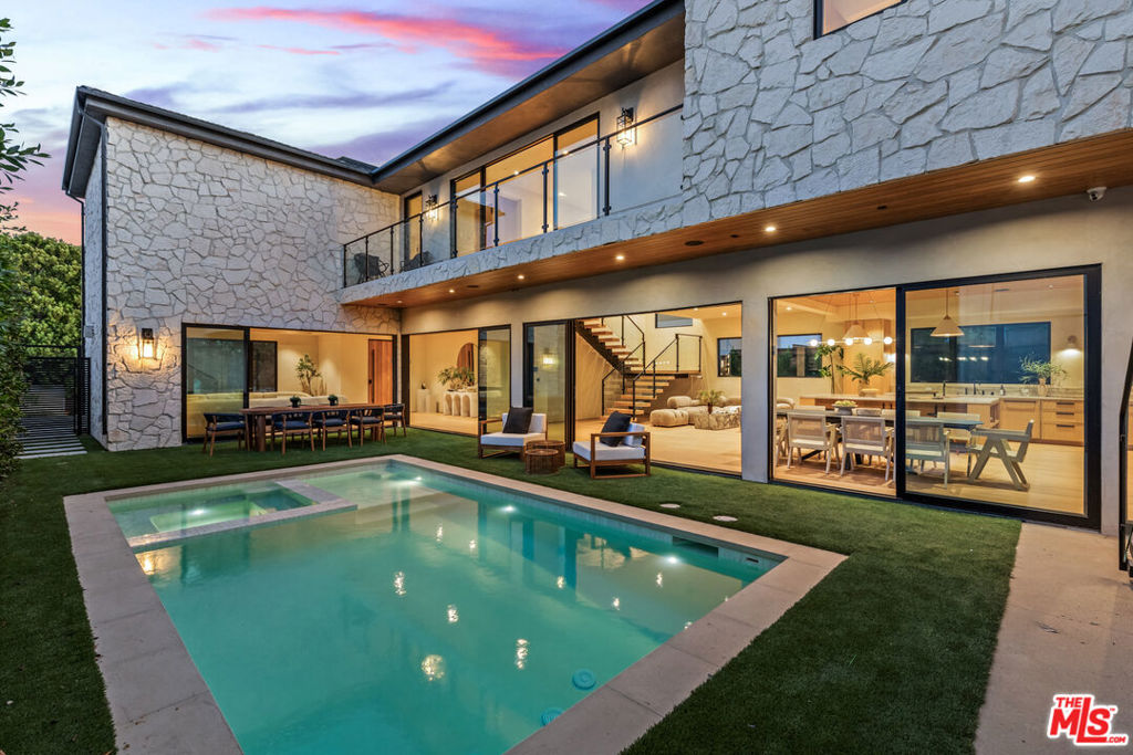 Discover the pinnacle of modern luxury in this one-of-a-kind, new construction designer home in the Mar Vista Hills, offering sweeping views to the Marina and an unmatched blend of sophistication, innovation, and architectural elegance. Spanning over 4,200 square feet including a fully appointed detached ADU, this masterpiece by D Design stuns with limewash-finished walls and ceilings, white oak floors, floating stairs, flush metal door frames, and canless recessed lighting for a seamless, gallery-like aesthetic. The chef's kitchen is a showstopper with Taj Mahal quartzite countertops, backsplash, and range hood, custom Gold Cabinetry, Watermark fixtures, and a built-in outdoor BBQ with dedicated dining space for incredible indoor-outdoor living. Every bathroom is a spa-like retreat with Zellige tile and Phylrich fixtures, while the powder room boasts a striking Calacatta Viola porcelain vanity. Smart home living is fully realized with a Control 4 system, surround sound in every room, two tankless water heaters, dual AC units, and even a private designated fire hydrant exclusive to the property. Outside, a sparkling pool and spa complete this rare offering in one of Los Angeles' most sought-after enclaves - an extraordinary opportunity for elevated coastal living.
